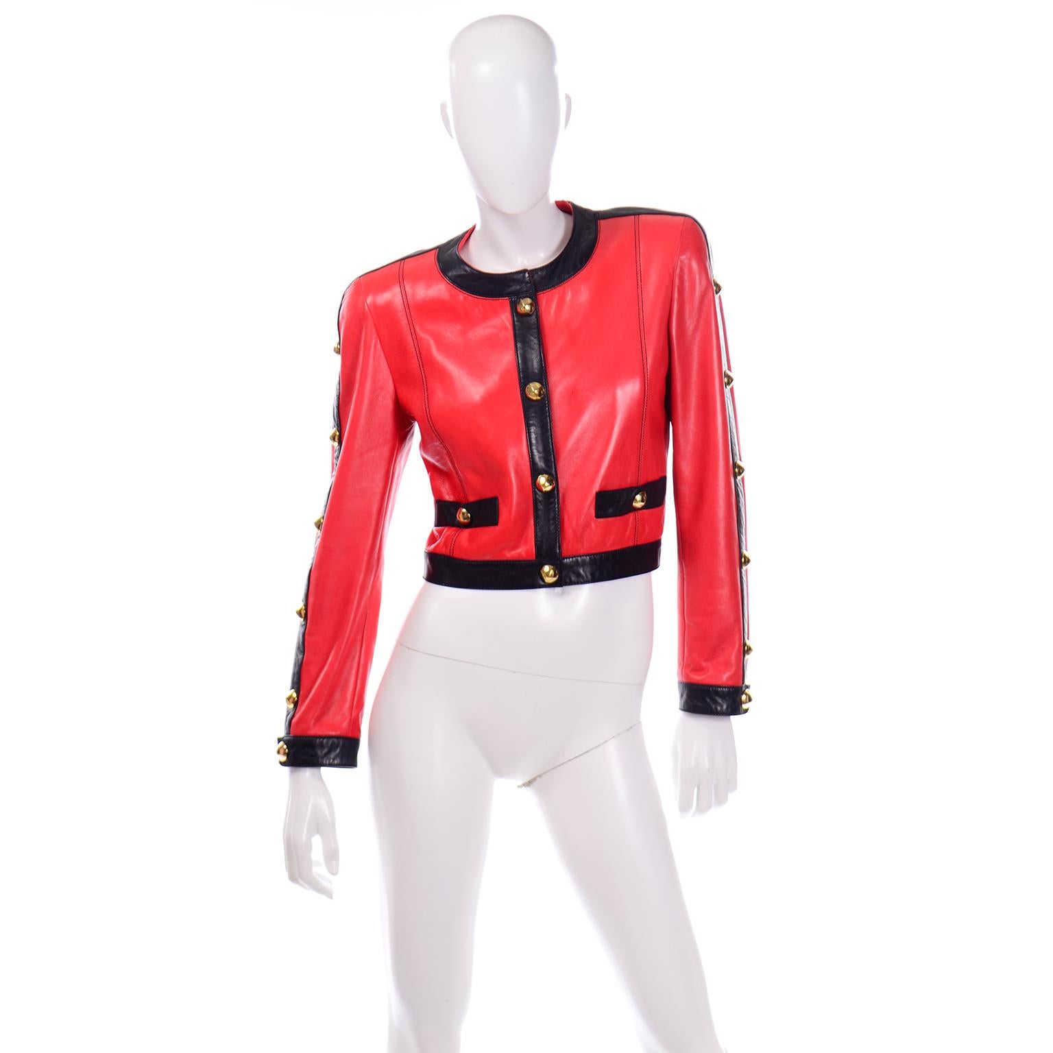 This vintage Escada short leather jacket is absolutely amazing! The jacket was designed by Margaretha Ley in the 1980's and is made of a luxurious red leather with black leather trim on the collar, hem, sleeves and pockets. There are fabulous big