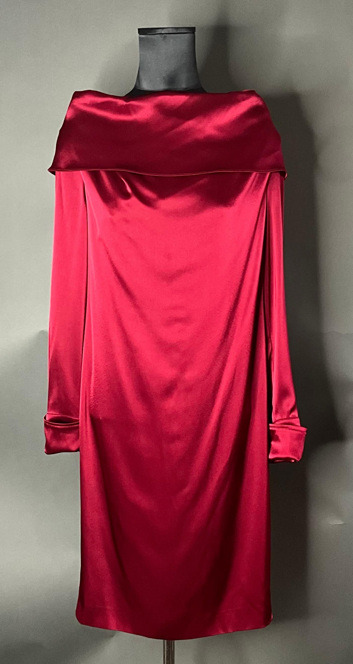 The Vintage Escada Red Off-the-Shoulder Dress is a bold, luxurious, and timeless piece that embodies the elegance and sophistication of Escada. This dress drapes beautifully on the body, with an off-the-shoulder design that is both flattering and