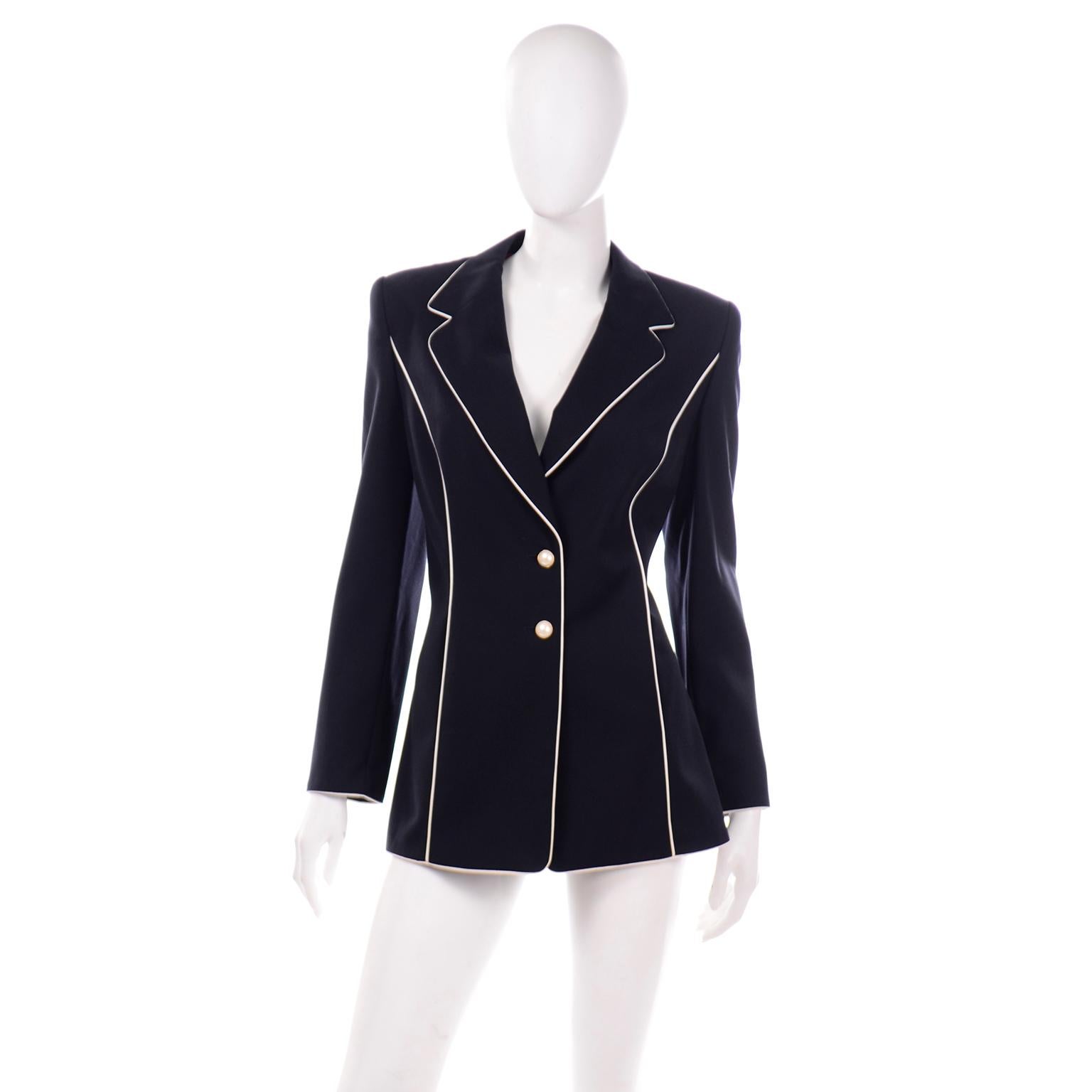 We love vintage Escada and this great vintage 1990's jacket could be a staple in any modern wardrobe! The blazer style jacket has beautiful white piping that contrasts so nicely with the dark, midnight blue (almost black) fabric. The piping trims