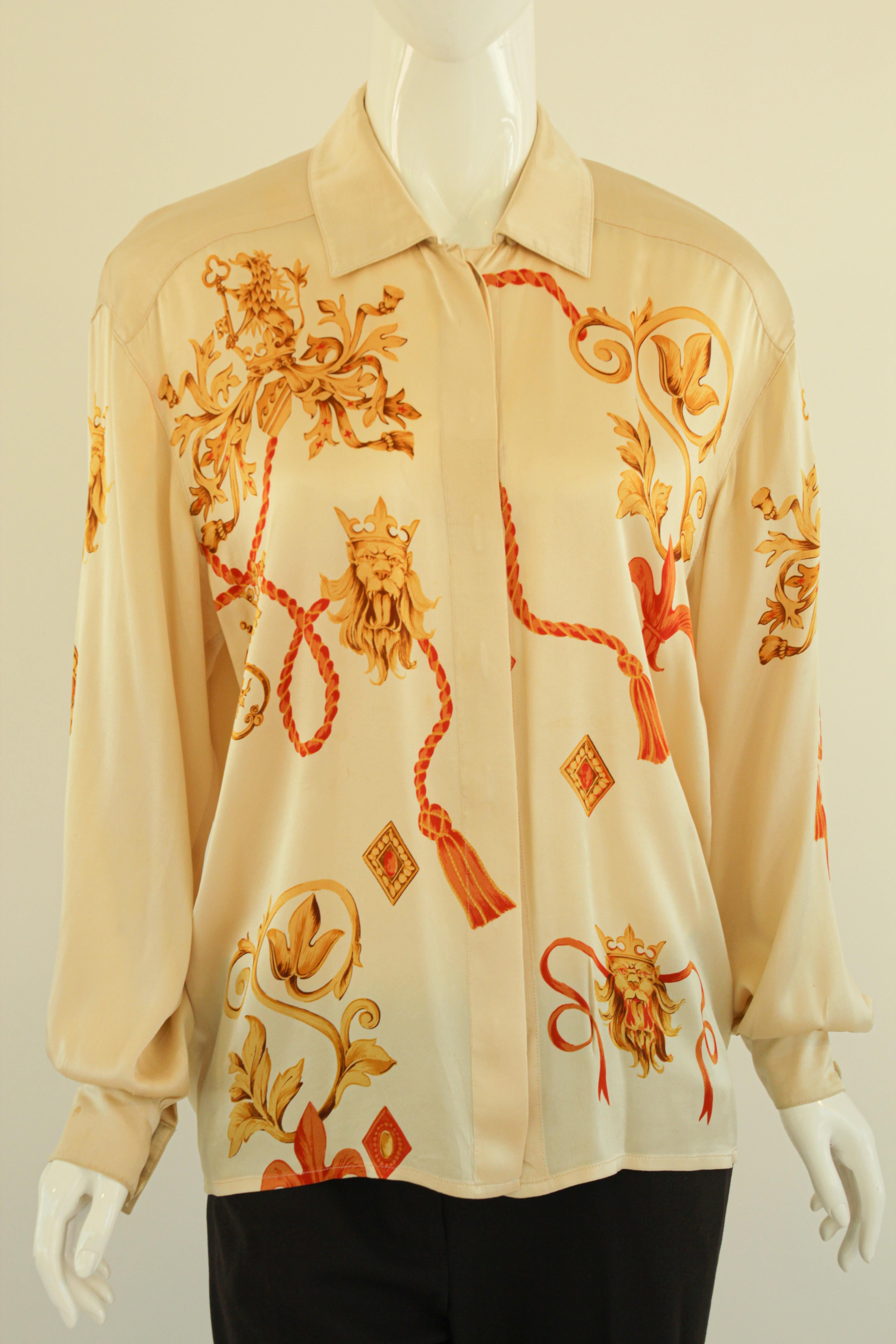 ESCADA
1980s vintage Escada cream color silk shirt blouse.
 Since this top is from the 1980's it is a little oversized so it measures more like a size 8.
A shirt like this from Escada is just what you need in your wardrobe. 
Tailored from silk, it