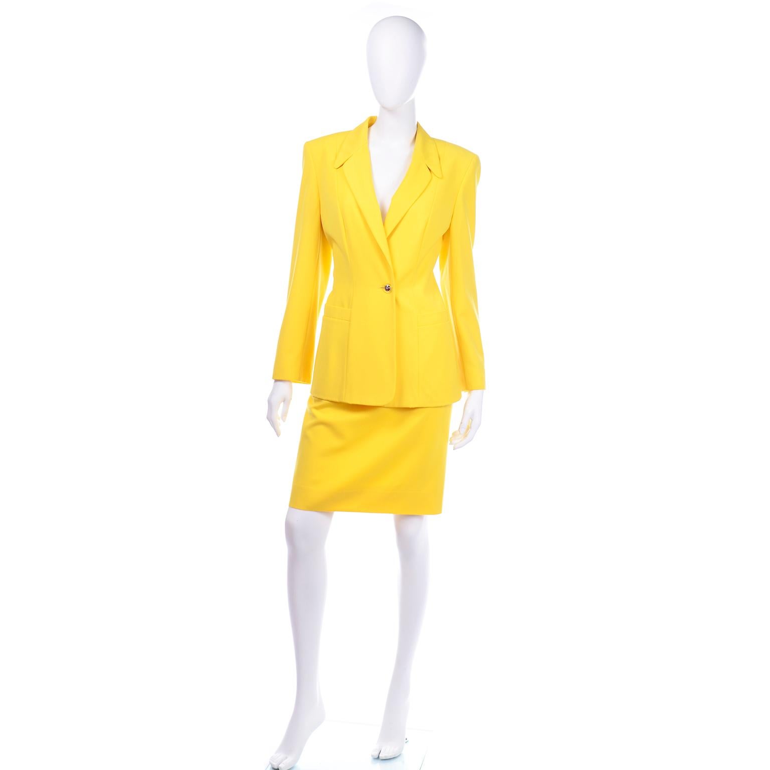 This is a gorgeous vintage yellow summer weight wool Escada skirt suit with the Margaretha Ley label. This beautifully tailored  jacket is a longline blazer with a pointed collar and dramatic shoulders. The front of the blazer has seams along the