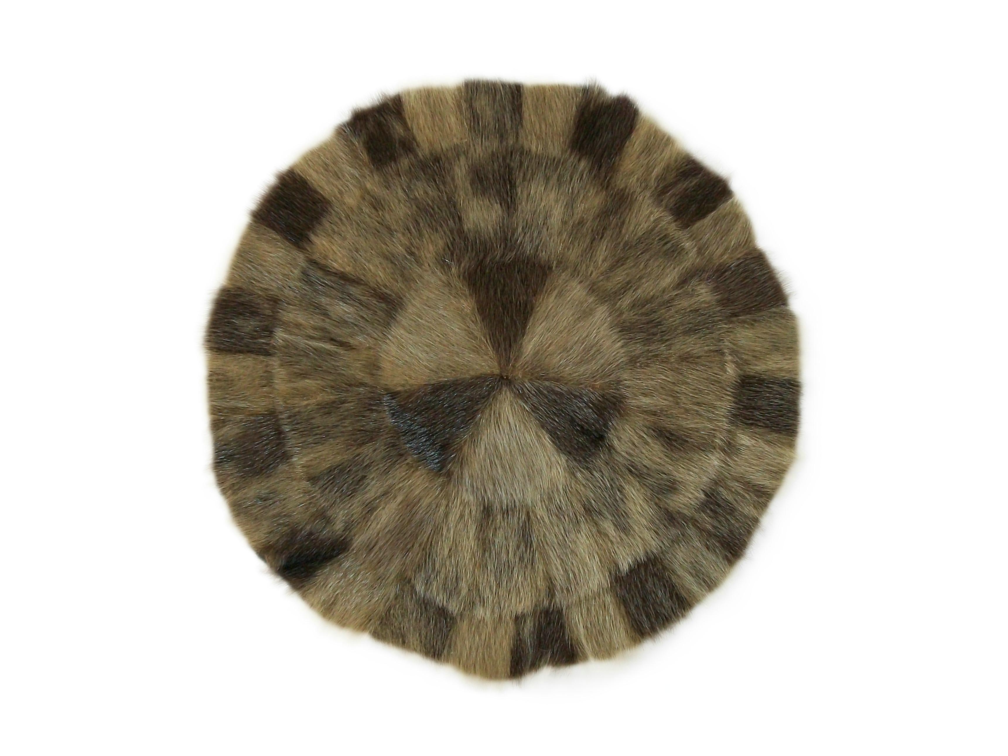 Rare vintage Eskimo / Inuit fur table mat - featuring a hand sewn radiating patchwork design with subtle color shifts - original quilted satin lining - original satin label to the back - unknown maker - Canada - circa 1950's.

Excellent vintage