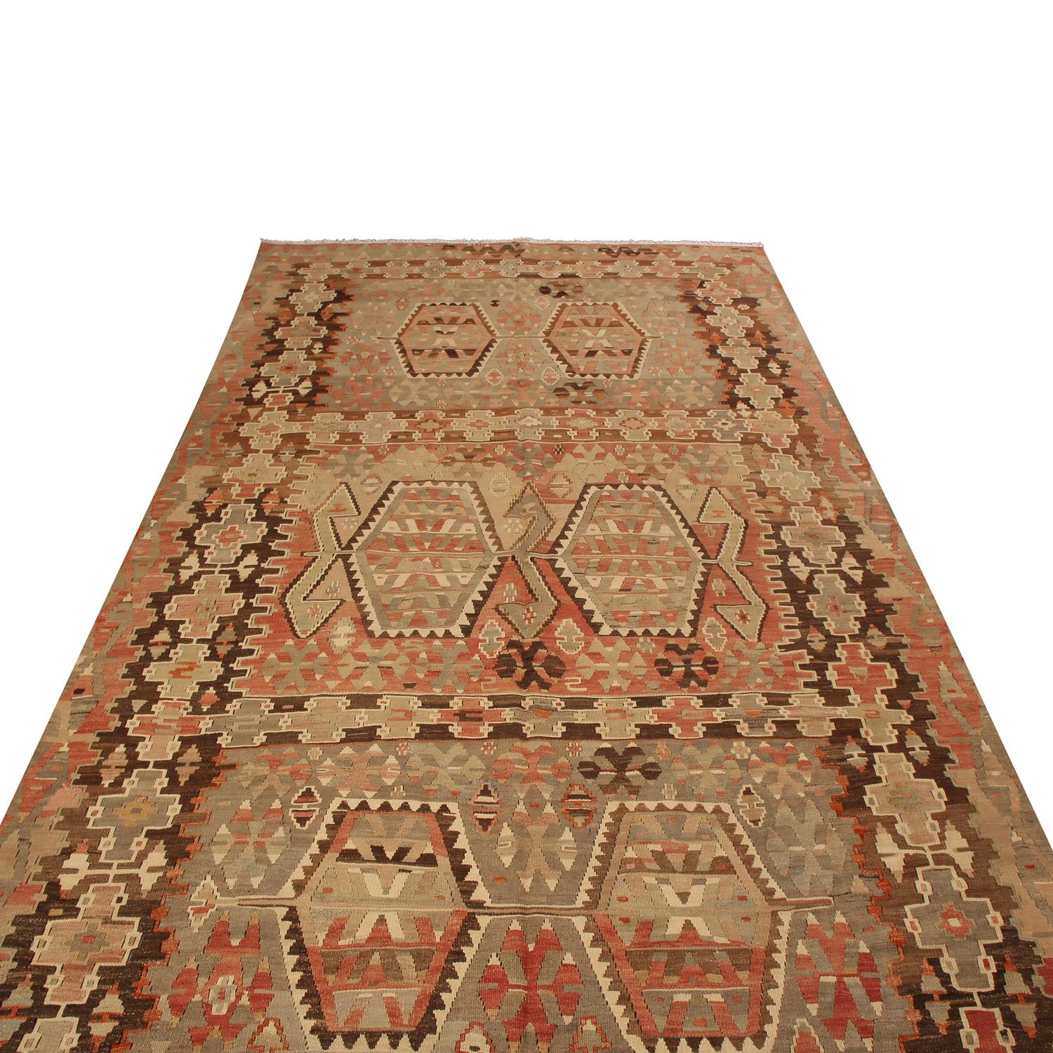 Originating from Turkey between 1940-1950, this vintage Esme wool Kilim rug features a high-quality flat-weave and a unique, vibrant array of field colorways against the beige background, marrying a distinct pageantry of inviting pastels with an