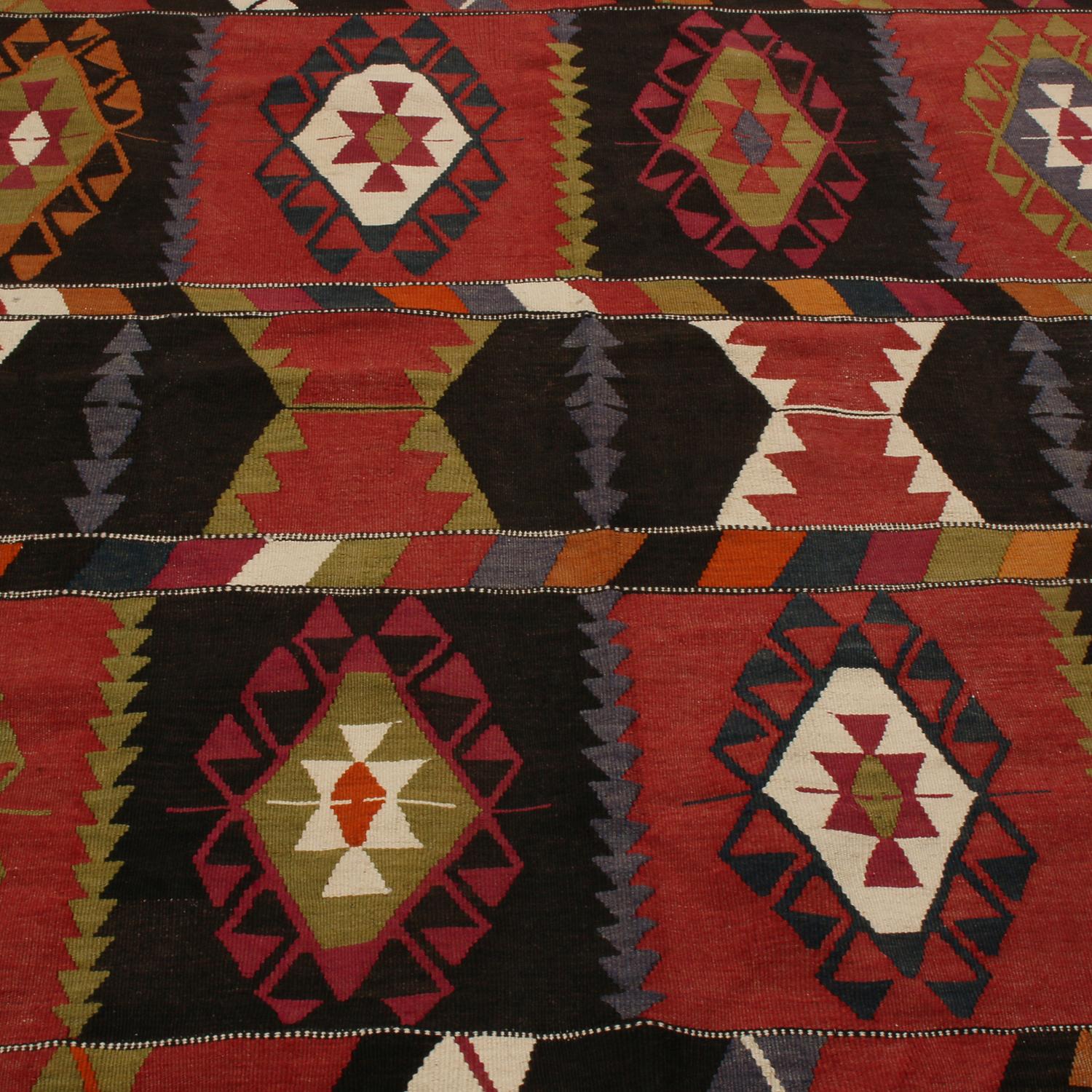 Flat-woven in high-quality wool originating from Turkey between 1940-1950, this vintage Esme Kilim rug enjoys one of the most unique variations of individualistic colorways throughout its patterns, celebrating multi-tonal hues of red, green, blue,