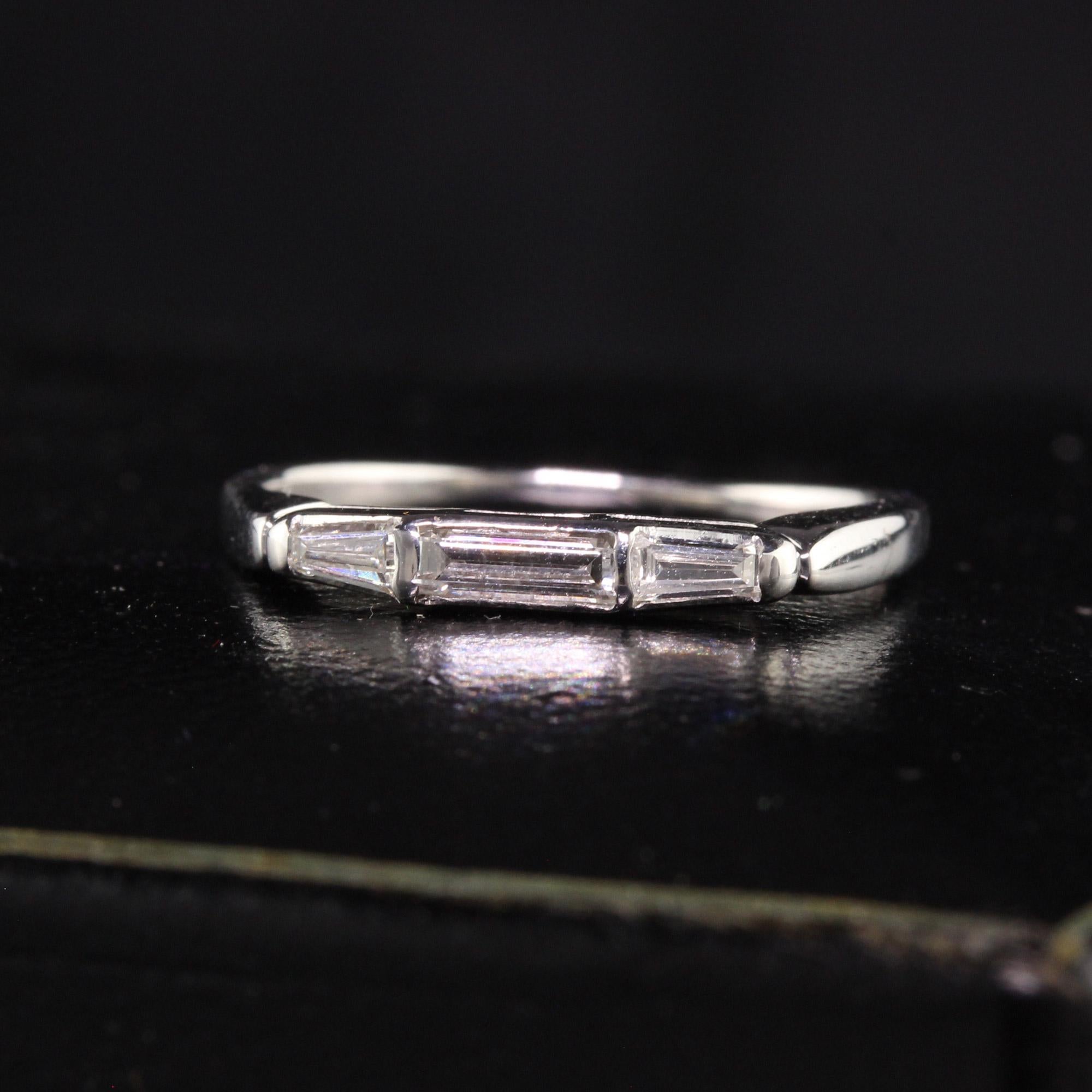 Beautiful Vintage Estate 14K White Gold Baguette Diamond Three Stone Band. This classic band features three baguette diamonds on the top set in 14K white gold. It can be worn with an engagement ring or by itself.

Item #R1105

Metal: 14K White