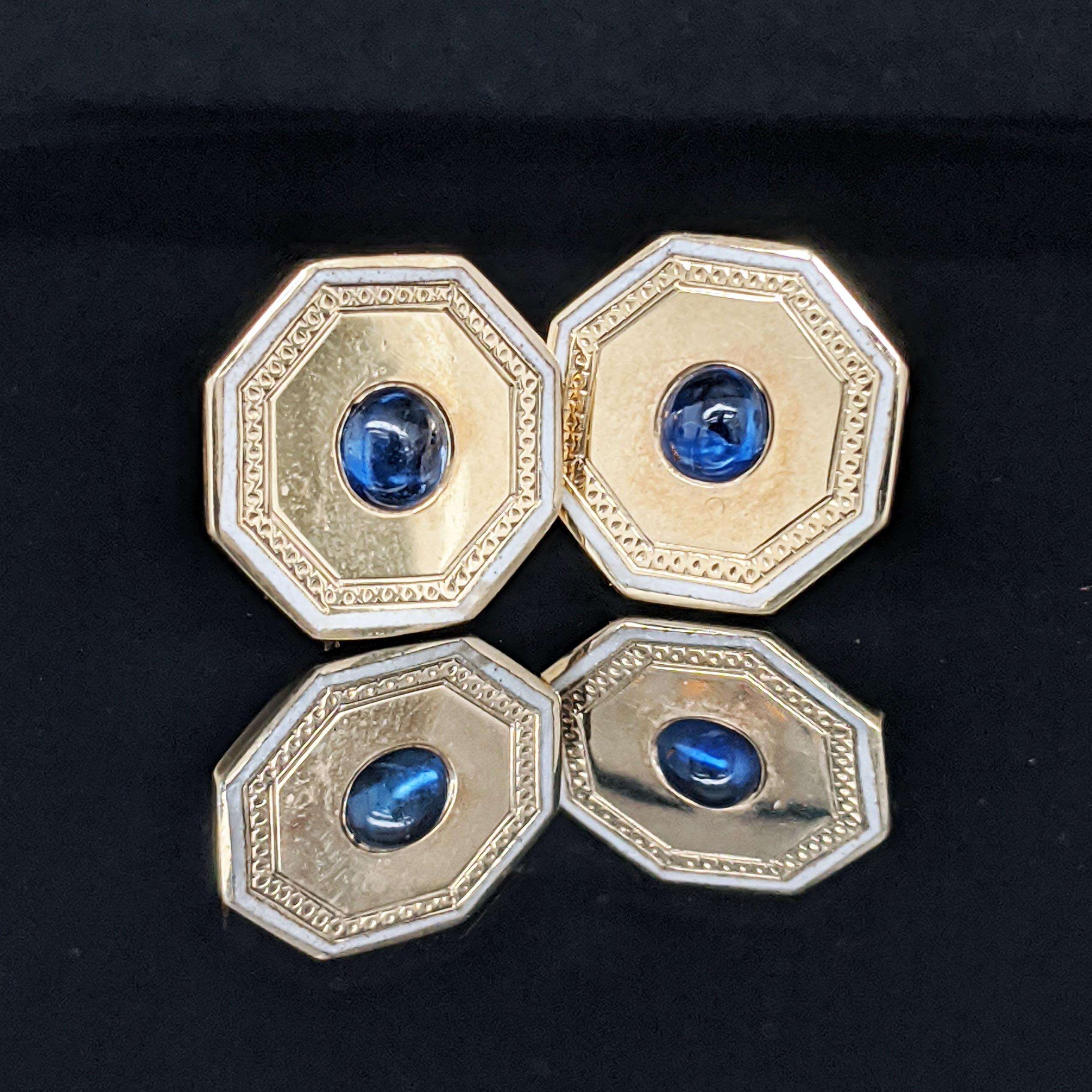 This is an awesome pair of vintage estate earrings in 14k yellow gold with blue sapphire cabochon centers that were converted from a set of cufflinks! The earrings have a slim octagonal shape with a finely engraved border detail of off white enamel.