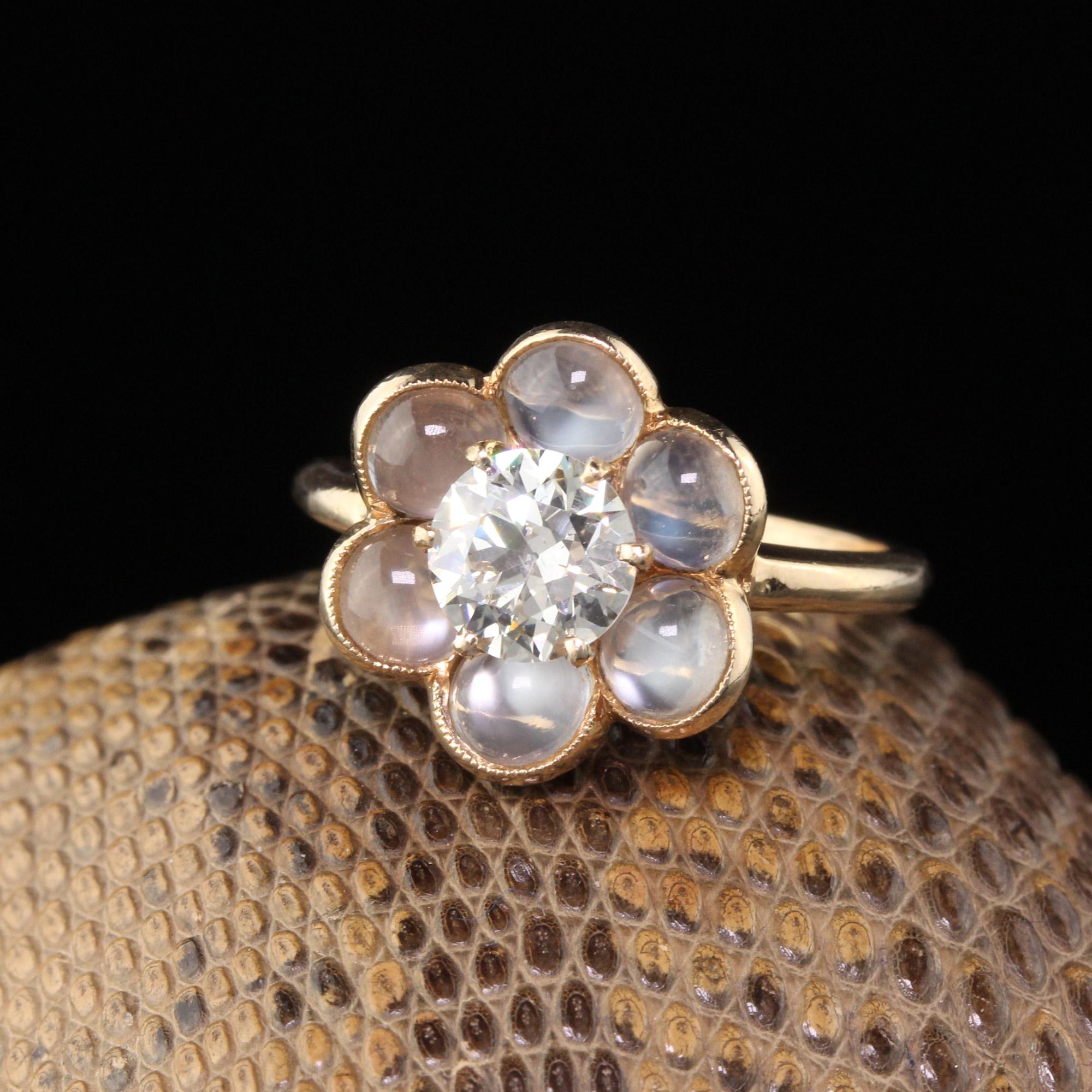 Stunning and very unique vintage engagement ring featuring a 0.88 ct old european cut diamond in the center surrounded by a halo of moonstones creating a flower shop. Magical!

#R0391

Metal: 14K Yellow Gold 

Weight: 3.2 Grams

Diamond Weight: 0.88