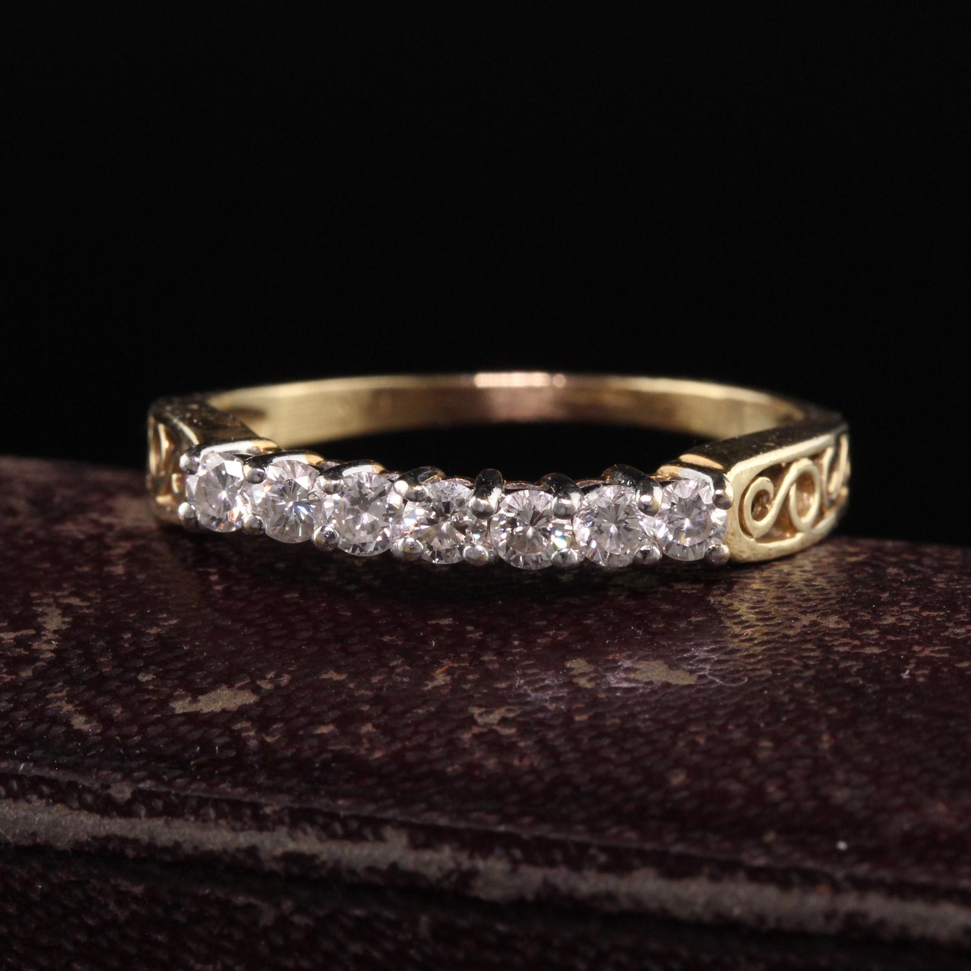 Beautiful Vintage Estate 14K Yellow Gold Two Tone Diamond Filigree Wedding Band. This classic ring is crafted in 14k yellow gold and white gold. The ring has seven diamonds on the top set in white gold prongs and the sides have filigree scroll work.