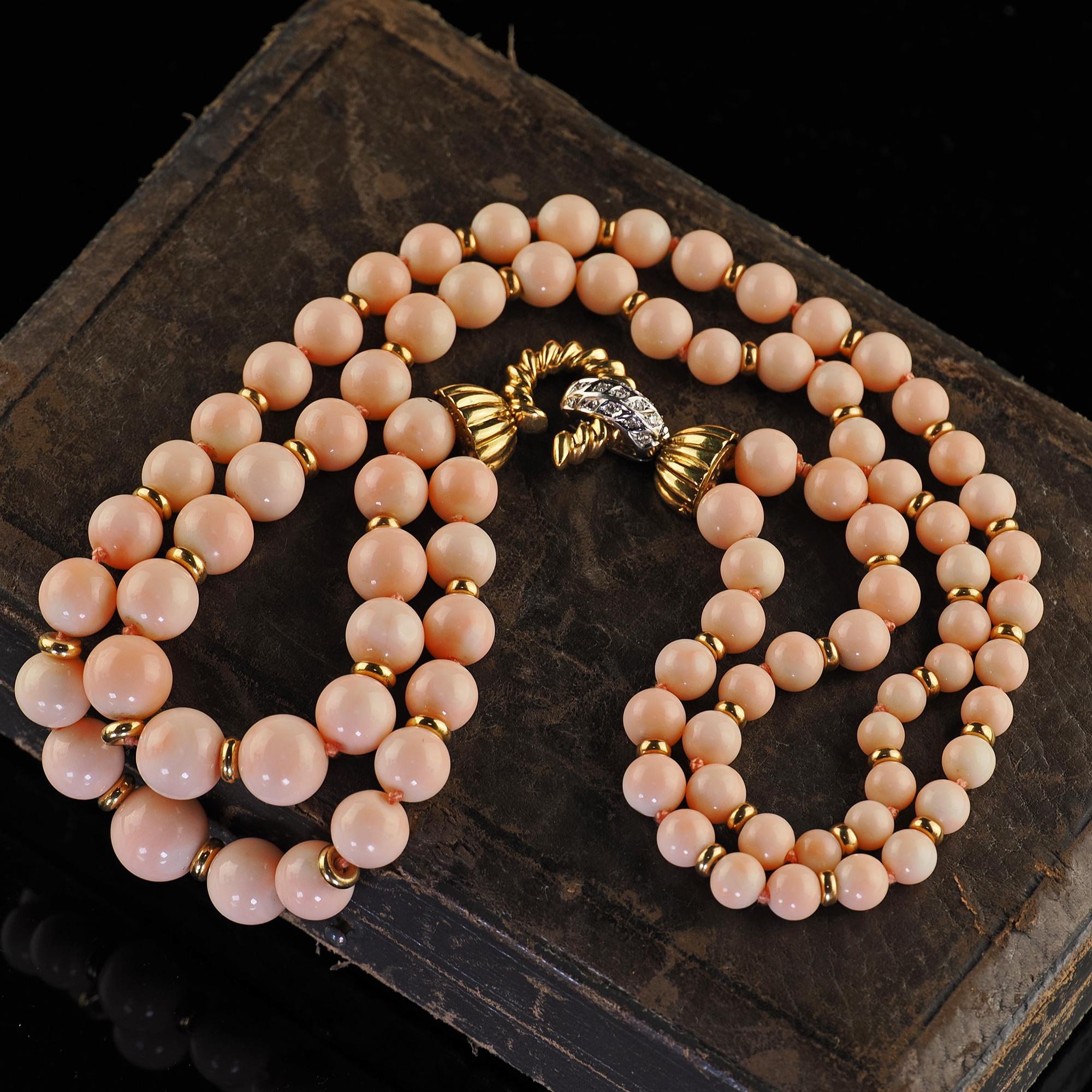 Beautiful Vintage Estate 18K Two Tone Gold Diamond Angel Skin Coral Double Strand Necklace. This beautiful Vintage estate diamond and angel skin coral necklace is crafted in 18k yellow and white gold. The necklace features two strands of graduated