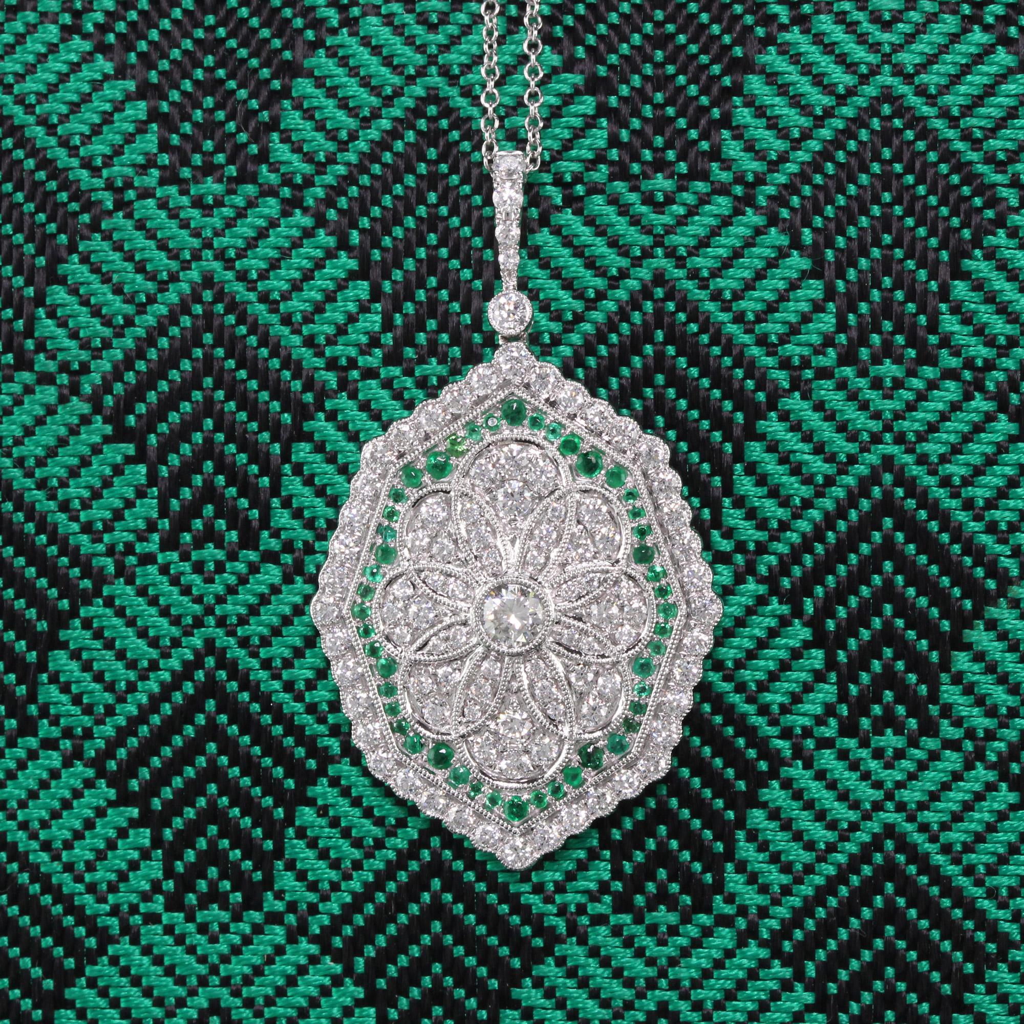 Gorgeous emerald and diamond pendant with dazzling diamond center.

Metal: 18K White Gold

Weight: 8.1 Grams

Diamond Weight: Approximately 1.20 ct.

Diamond Color: G

Diamond Clarity: VS2

Gemstone Weight: Approximately 0.50 ct.