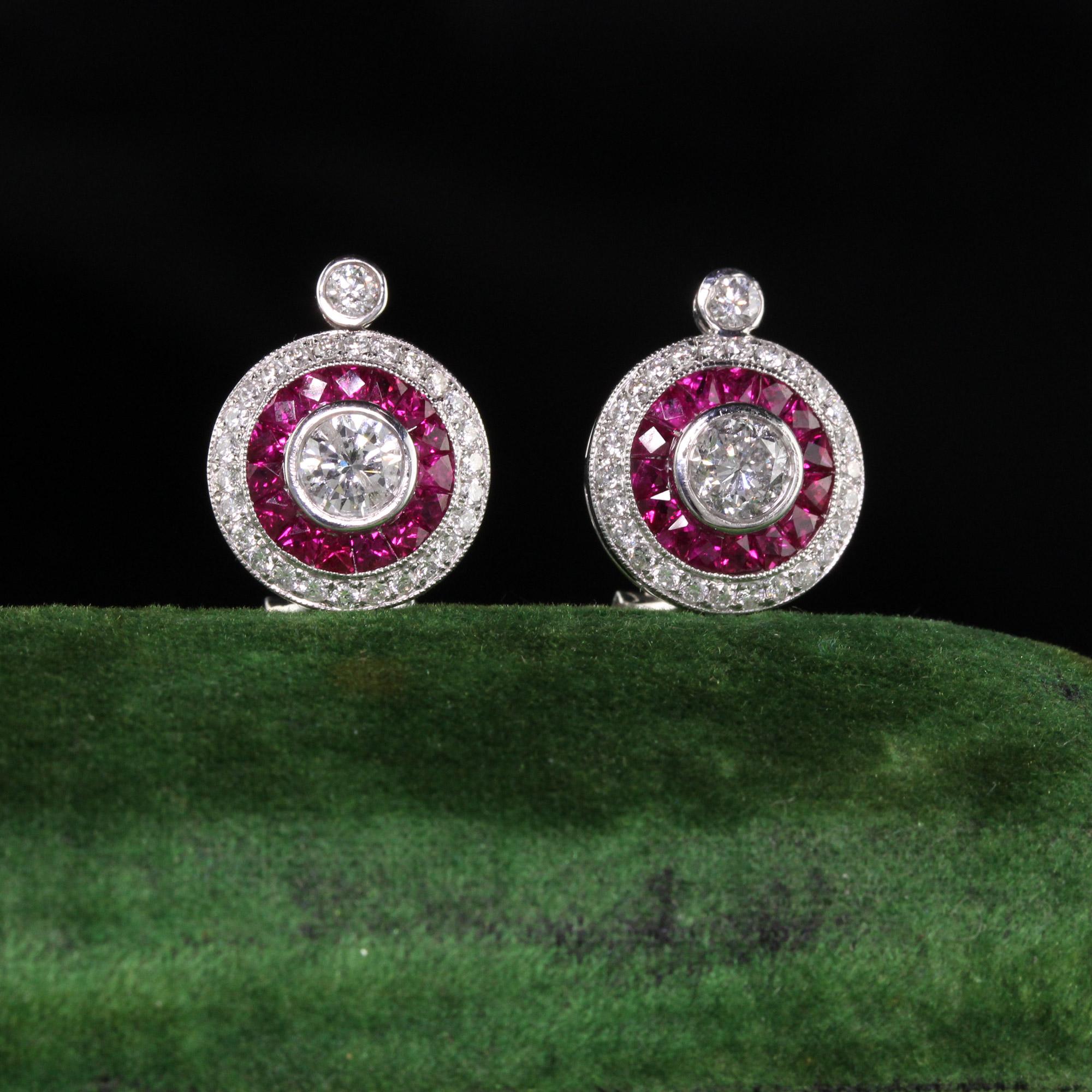 Gorgeous ruby and diamond earrings with dazzling center stone.

Metal: 18K White Gold

Weight: 6.6 Grams

Total Diamond Weight: Approx. 1.25 ct.

Center Diamond Weight: Approx. 0.70 ct.

Center Diamond Color: H

Center Diamond Clarity: Si1

Gemstone