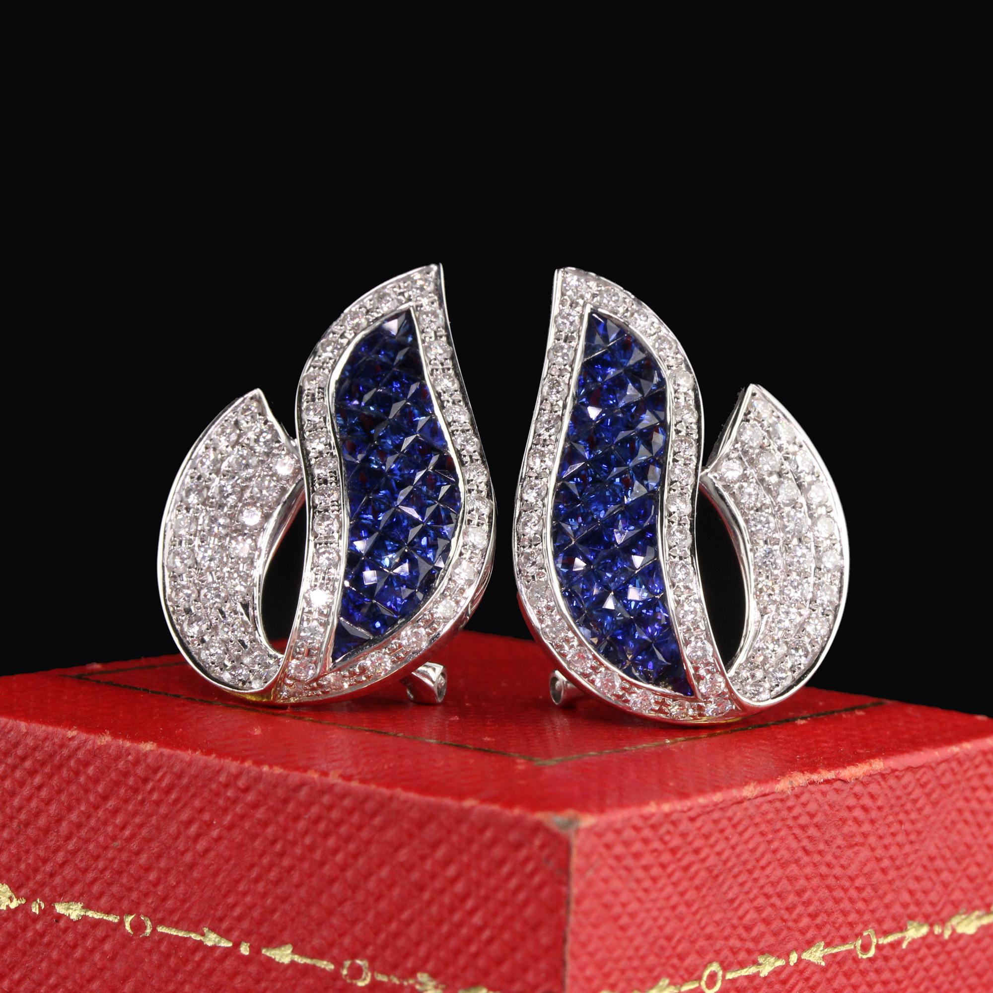 Dazzling sapphire and diamond earrings with elaborate design.

Metal: 18K White Gold

Weight: 9.2 Grams

Diamond Weight: Approx. 2 ct.

Diamond Color: G

Diamond Clarity: VS2

Gemstone Weight: Approx. 5 ct. sapphire

Measurements: 26.20 x 18.52 mm