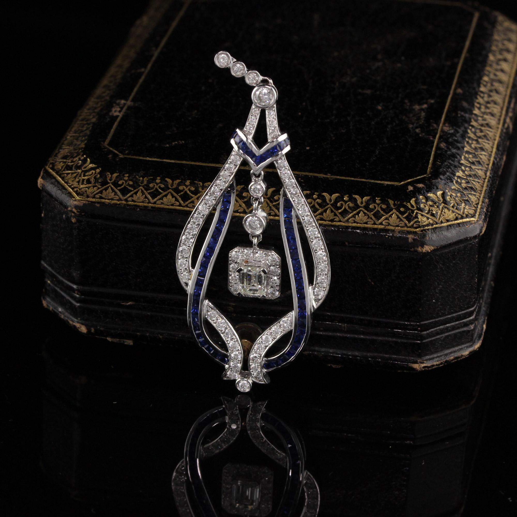 Gorgeous sapphire and diamond pendant with dazzling diamond center.

Metal: 18K White Gold

Weight: 10.5 Grams

Diamond Weight: Approximately 1.50 ct.

Diamond Color: H

Diamond Clarity: SI1

Gemstone Weight: Approximately 1 ct.