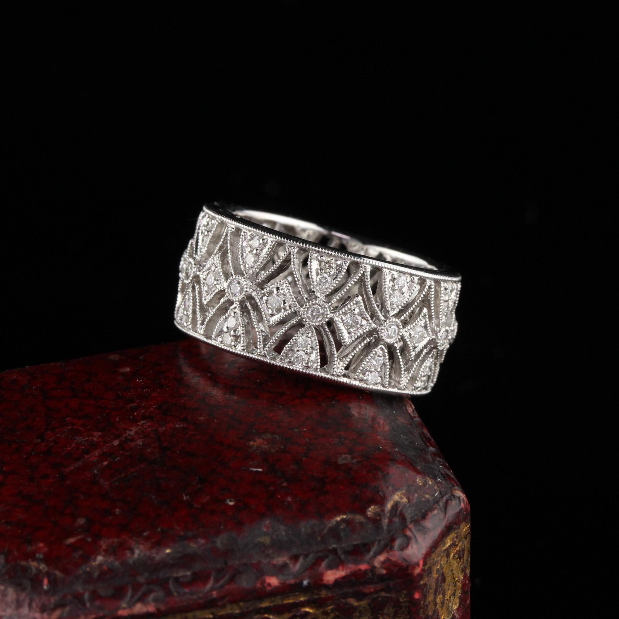 Dazzling diamond band with intricate design

Metal: White Gold

Weight: 10.5 Grams

Total Diamond Weight: Approximately 1 ct

Diamond Color: H

Diamond Clarity: SI1

Ring Size: 7

Measurements: 10.4 x 2.9 mm