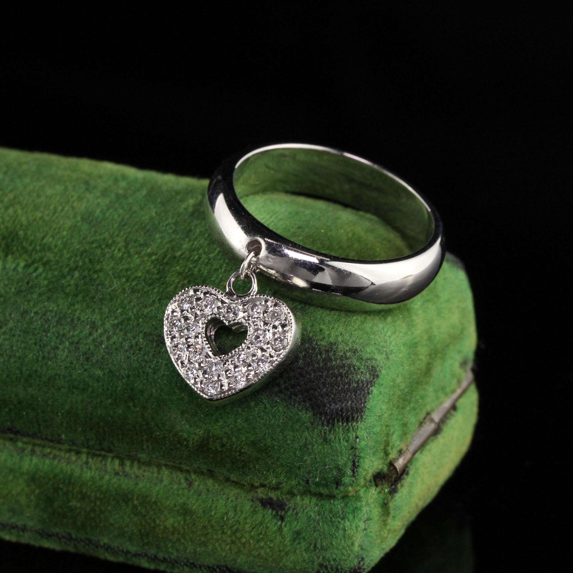 Gorgeous white gold ring with dazzling diamond heart charm.

Metal: 18K White Gold

Weight: 7.5 Grams

Total Diamond Weight: Approximately 0.50 ct.

Diamond Color: H

Diamond Clarity: SI1

Ring Size: 6.75 (sizable)

Measurements: Band measures 4.78