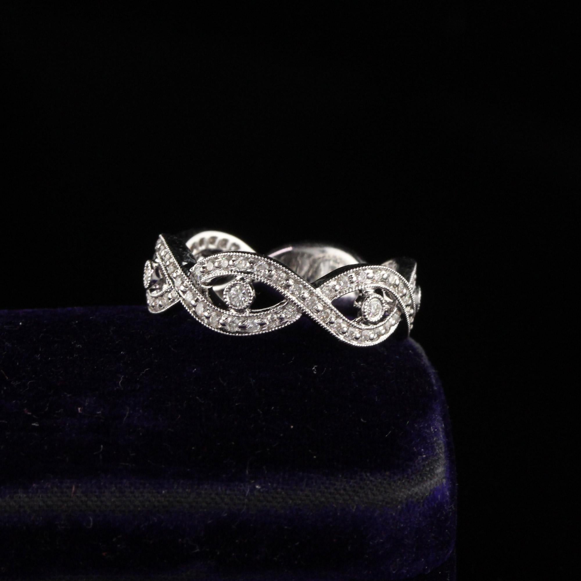 Gorgeous diamond band with twist design.

Metal: 18K White Gold

Weight: 5.9 Grams

Total Diamond Weight: Approximately 0.48 ct.

Diamond Color: G

Diamond Clarity: VS2

Ring Size: 6.75 (sizable)

Measurements: 6.62 x 3.28 mm