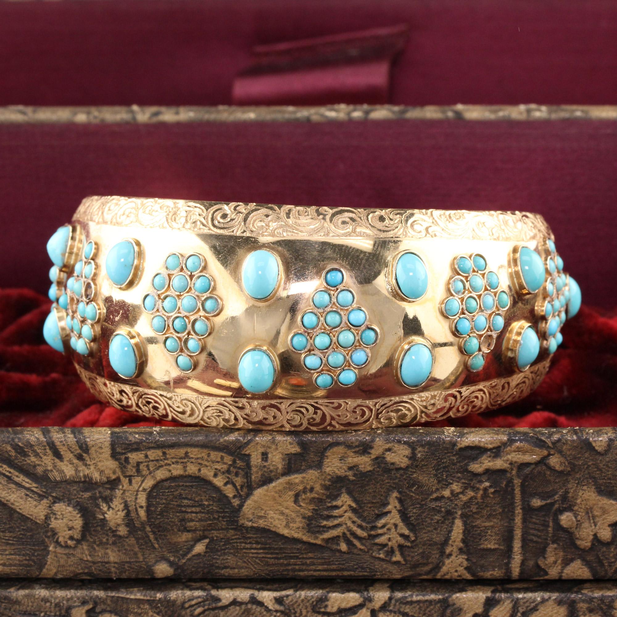 Fashionable yellow gold arm cuff set with turquoise. 

Metal: 18K Yellow Gold

Weight: 81.7 grams

Measurements: Width measures 0.34 inches. Fits 10 inch arm.