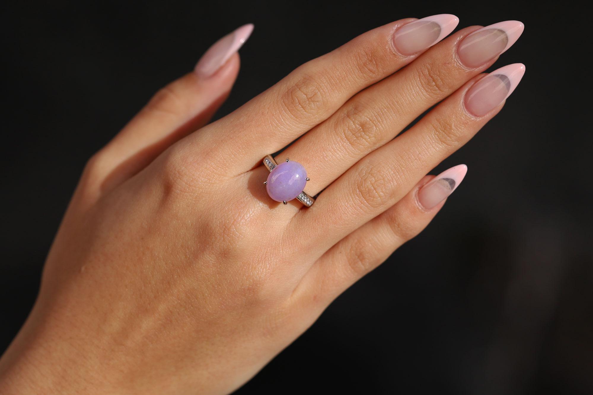 Bask in the beauty of this exceptional estate cocktail ring. The vintage stunner centers on a lesser seen lavender color jade, all natural and weighing 8.14 carats. 10 natural diamonds are expertly set in the platinum band, adding a loving touch of