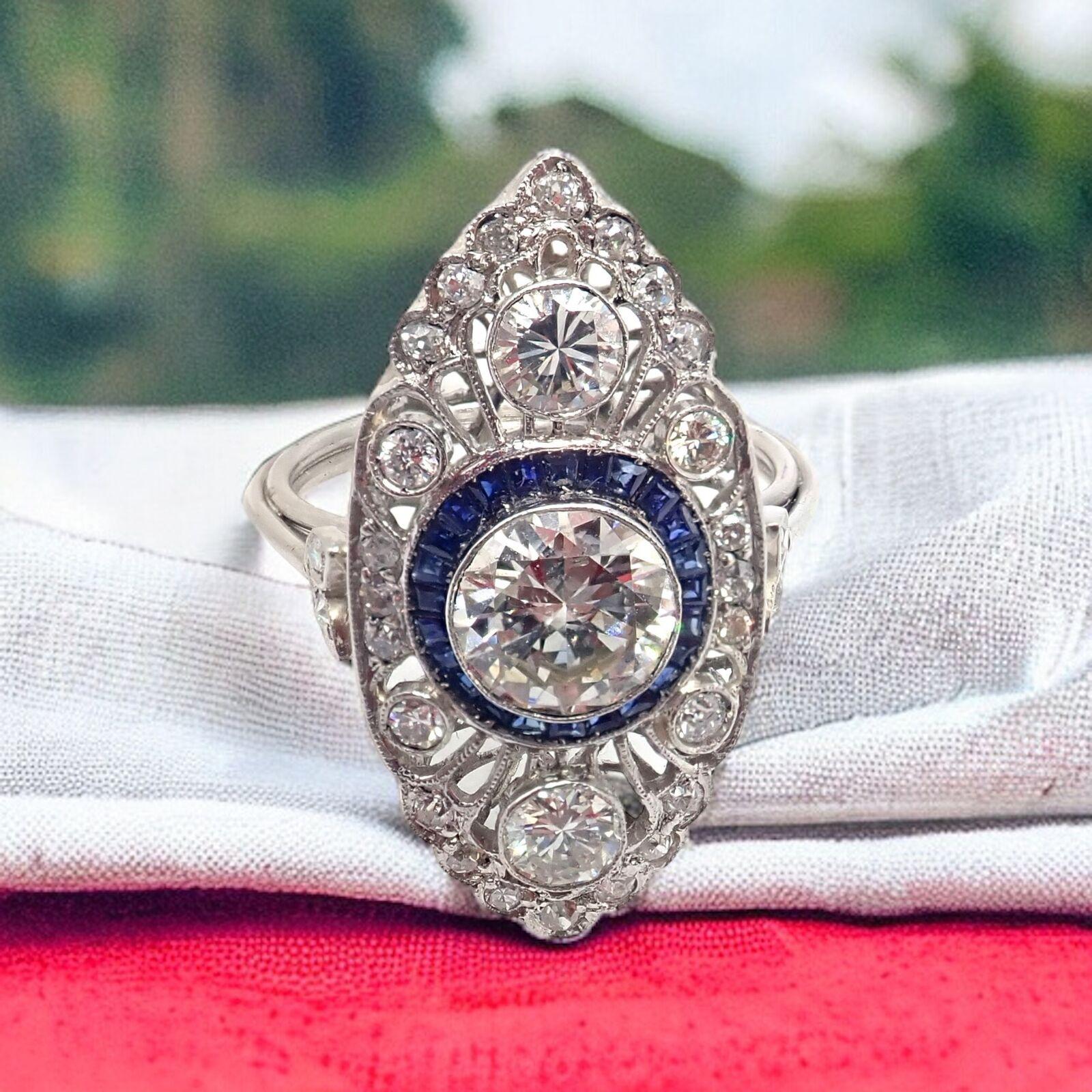 Platinum Art Deco Diamond And Sapphire Filigree Ring.
With 1 Old Euro cut diamonds approximately 1.04ct
Rest of diamonds equal approximately 0.76ct
Sapphires - Approximately 0.65ct
The Vintage Estate Platinum Art Deco Filigree Ring is a stunning