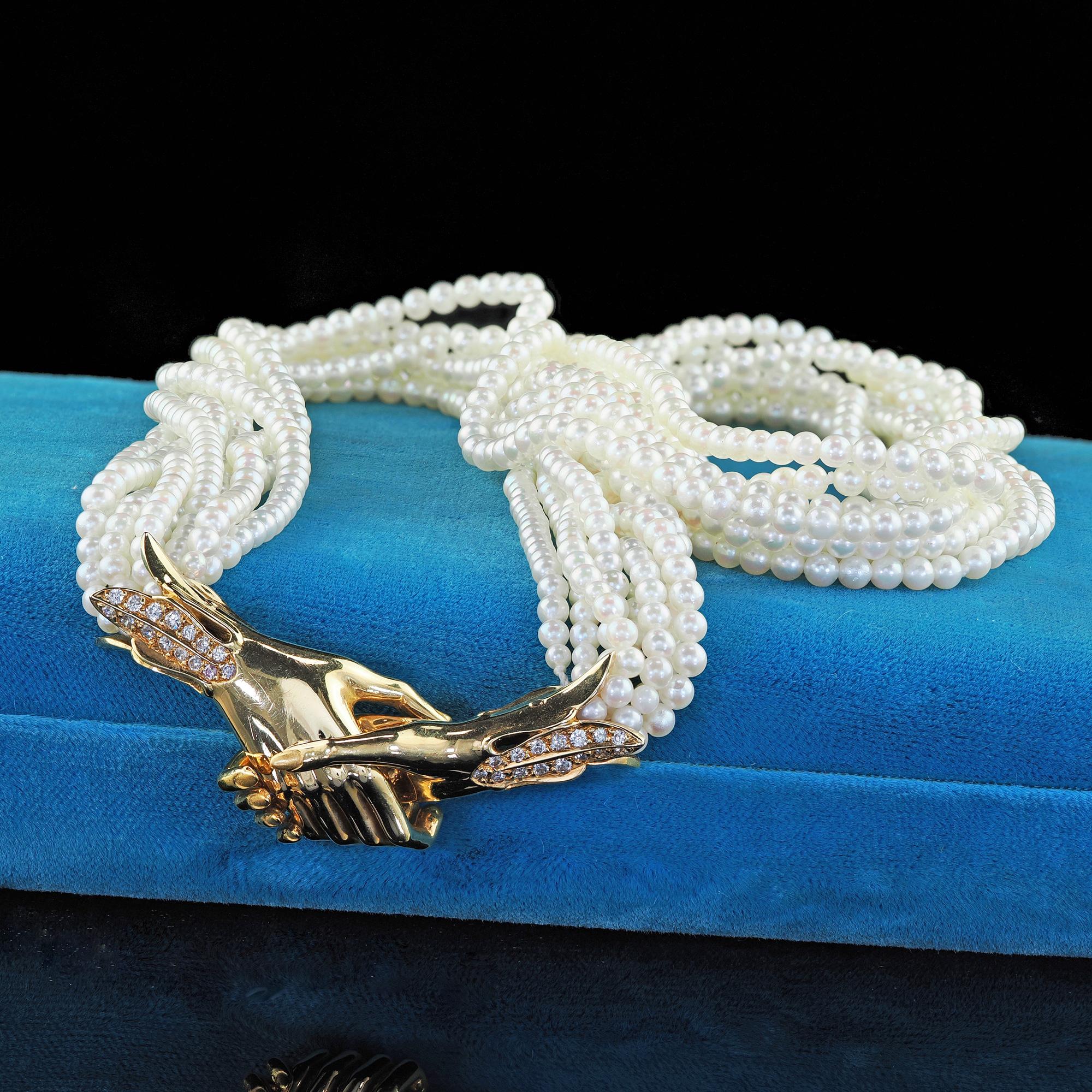 Beautiful Vintage Estate Carrera Y Carrera 18K Gold Diamond Holding Hands Pearl Necklace. This incredible Carrera Y Carrera holding hands pearl necklace is crafted in 18k yellow gold. This necklace features one male and female hand that interlock