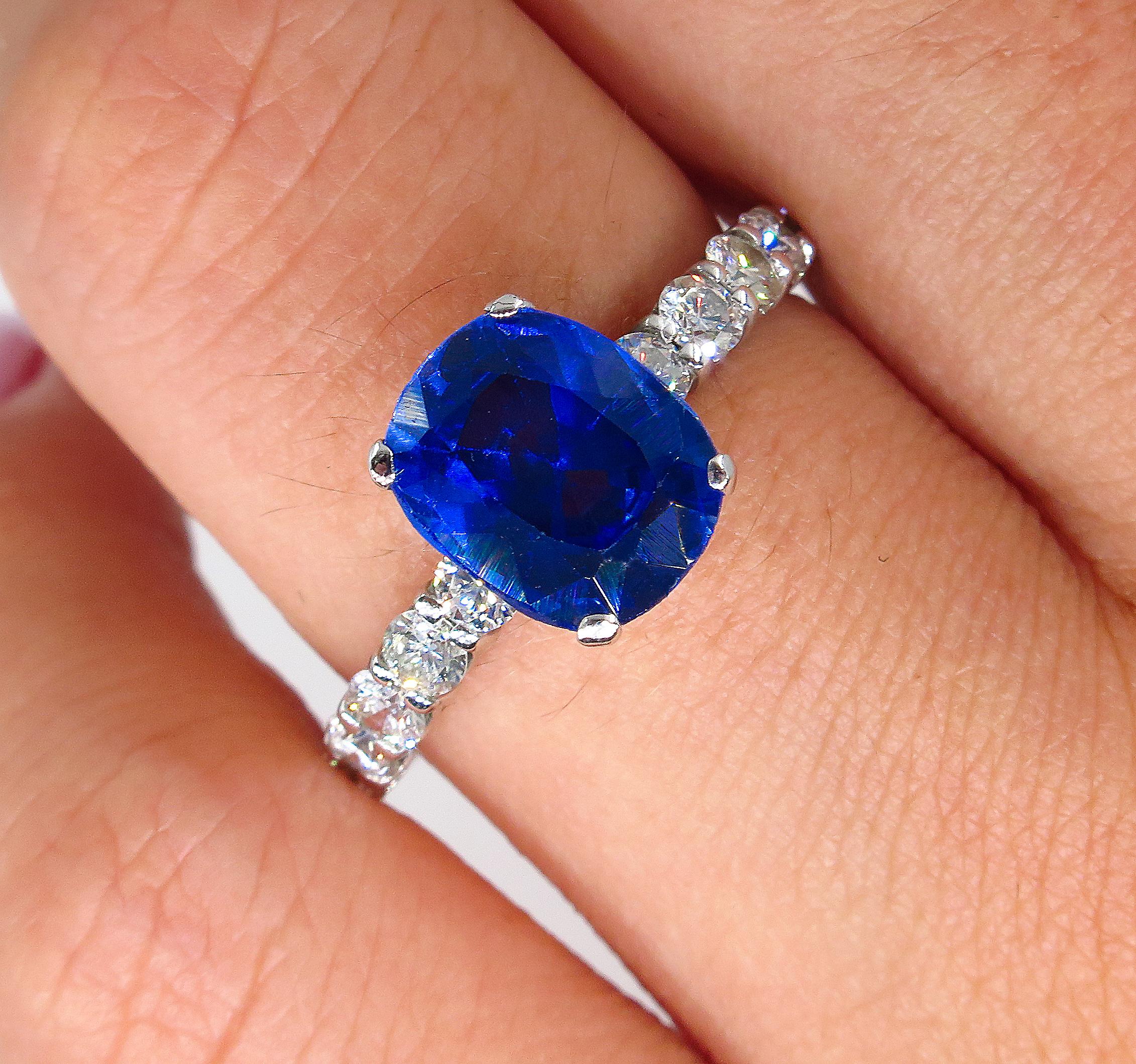 A Classic Style GIA certified Synthetic Cushion Shaped Blue Sapphire accented by sparkling round diamonds Ring. A wonderful Vintage Estate Jewel.
The impressive Midnight Blue gemstone shows all its weight in a graceful Cushion shape, measuring