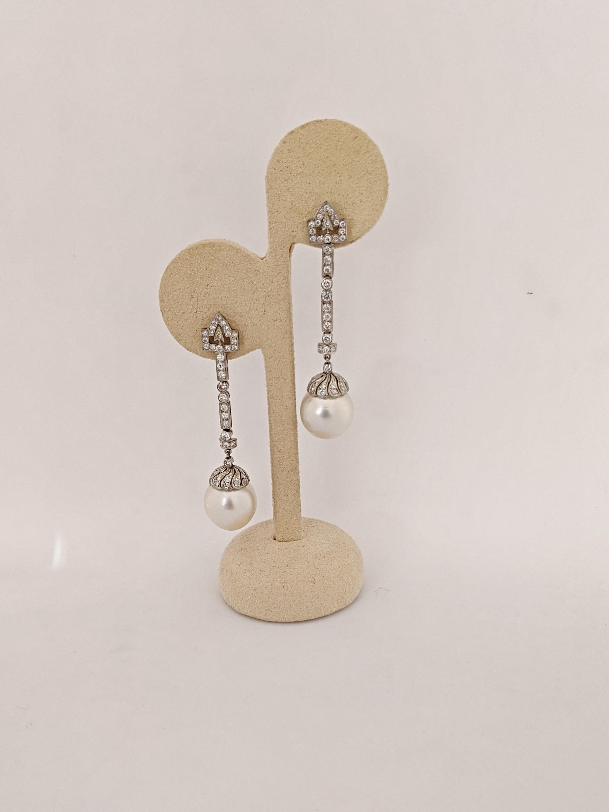 These elegant earrings are designed in an art deco style using the combination of rectangular, round , and triangle for the diamonds setting. The earrings measure 2