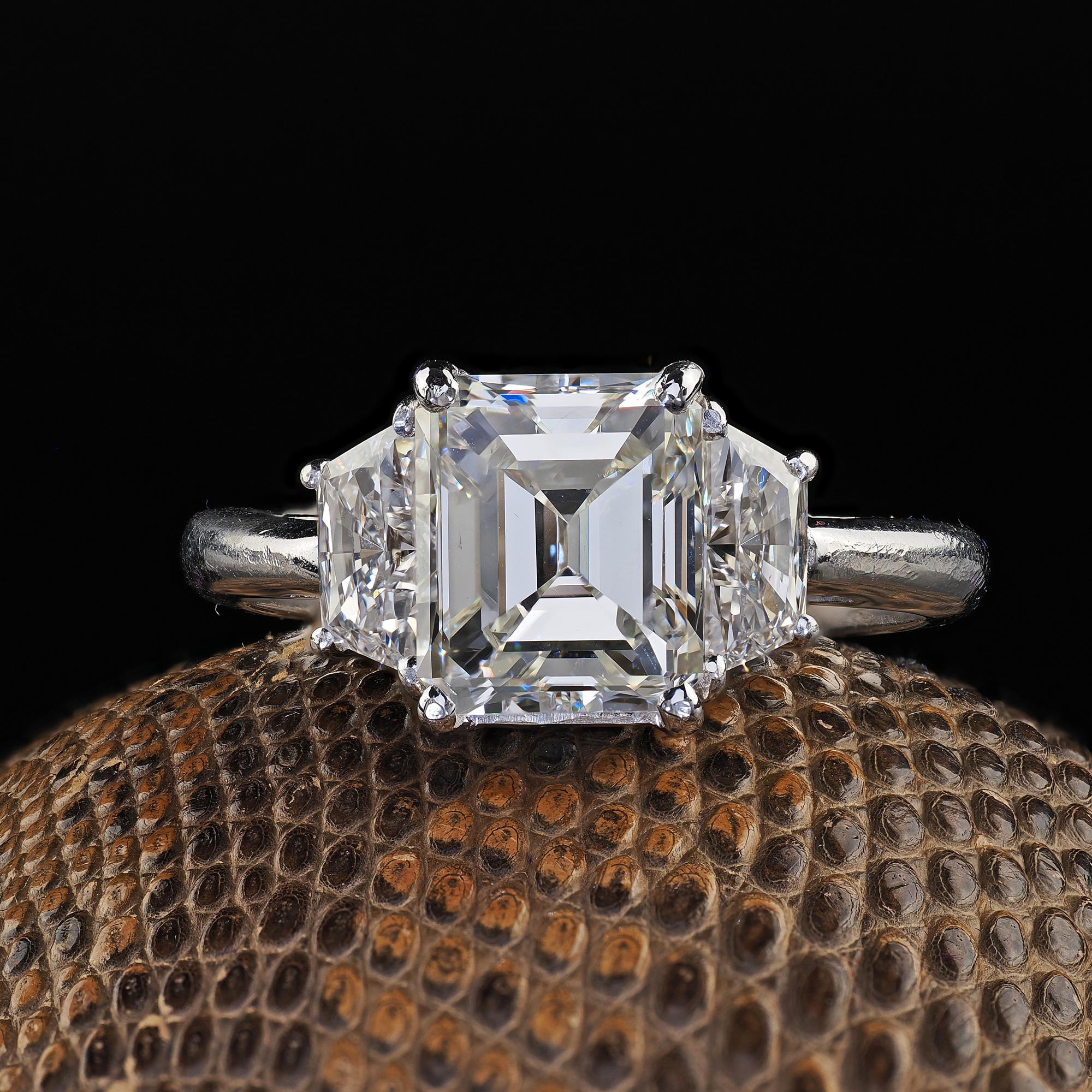Beautiful Vintage Estate Platinum Emerald Cut Diamond Three Stone Engagement Ring - GIA. This incredible Vintage emerald cut diamond three stone ring is crafted in platinum. This amazing ring features a large natural emerald cut diamond in the