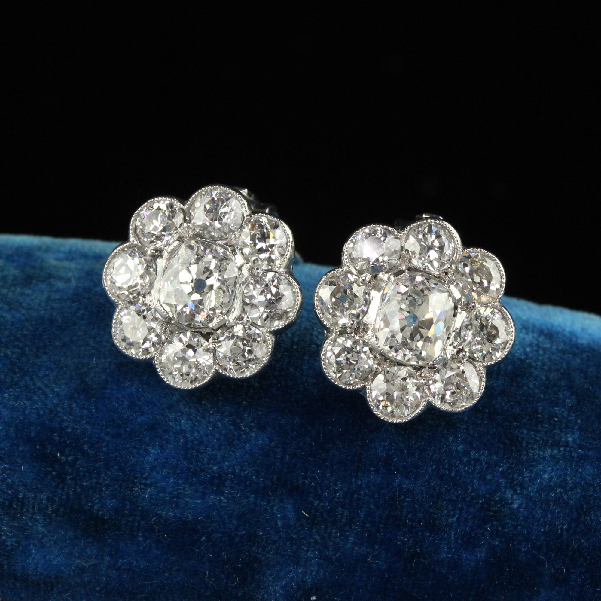 Beautiful Vintage Estate Platinum Old Mine and Old Euro Cut Diamond Flower Cluster Earrings. This gorgeous pair of old mine diamond earrings are crafted in platinum and 18k white gold clip backs. The center of the earrings have chunky elongated old