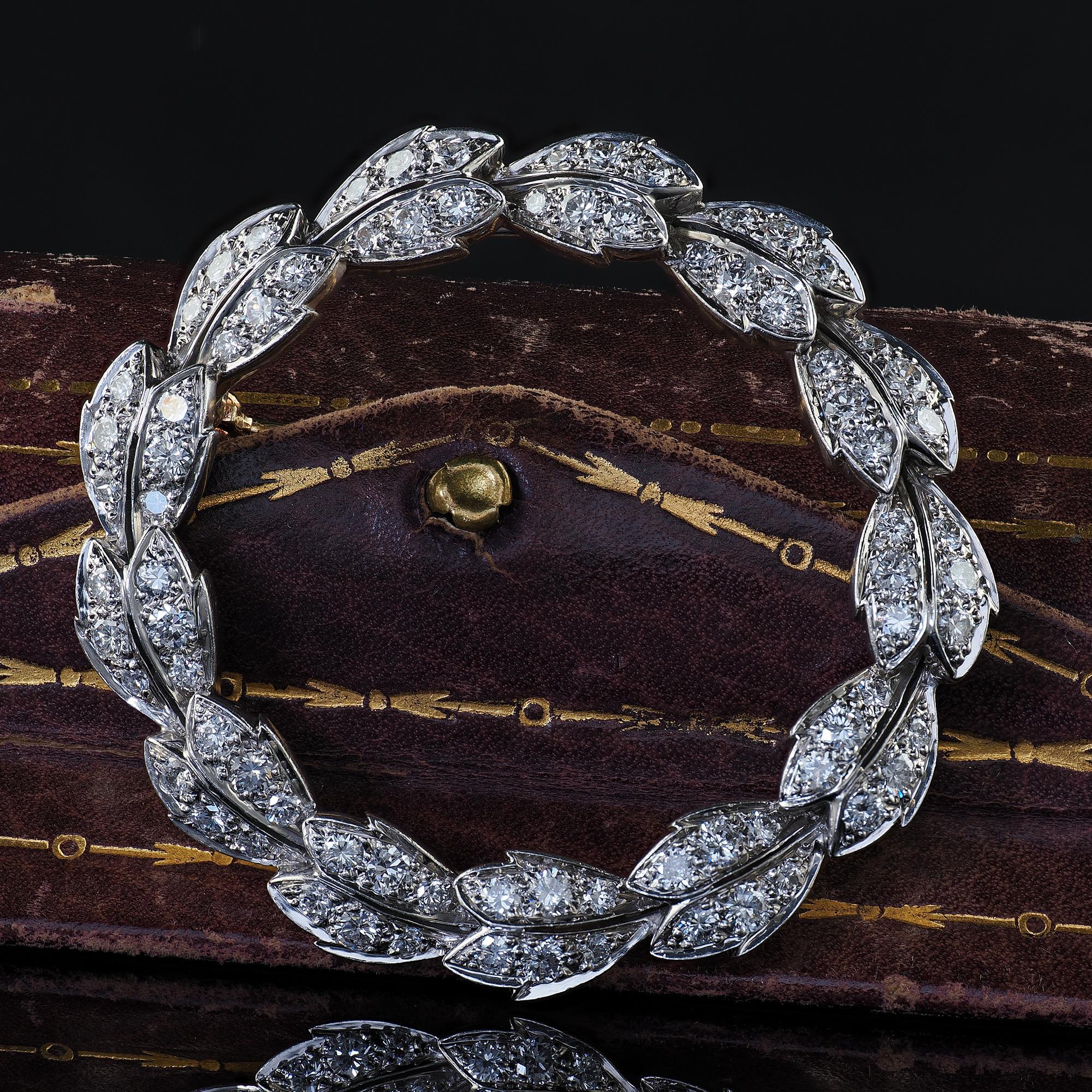 Beautiful Vintage Estate Tiffany and Co Platinum and Gold Diamond Wreath Pin Brooch. This gorgeous Tiffany and Co diamond wreath pin is crafted in platinum and 14k yellow gold pin closure. This gorgeous pin features round cut diamonds set throughout