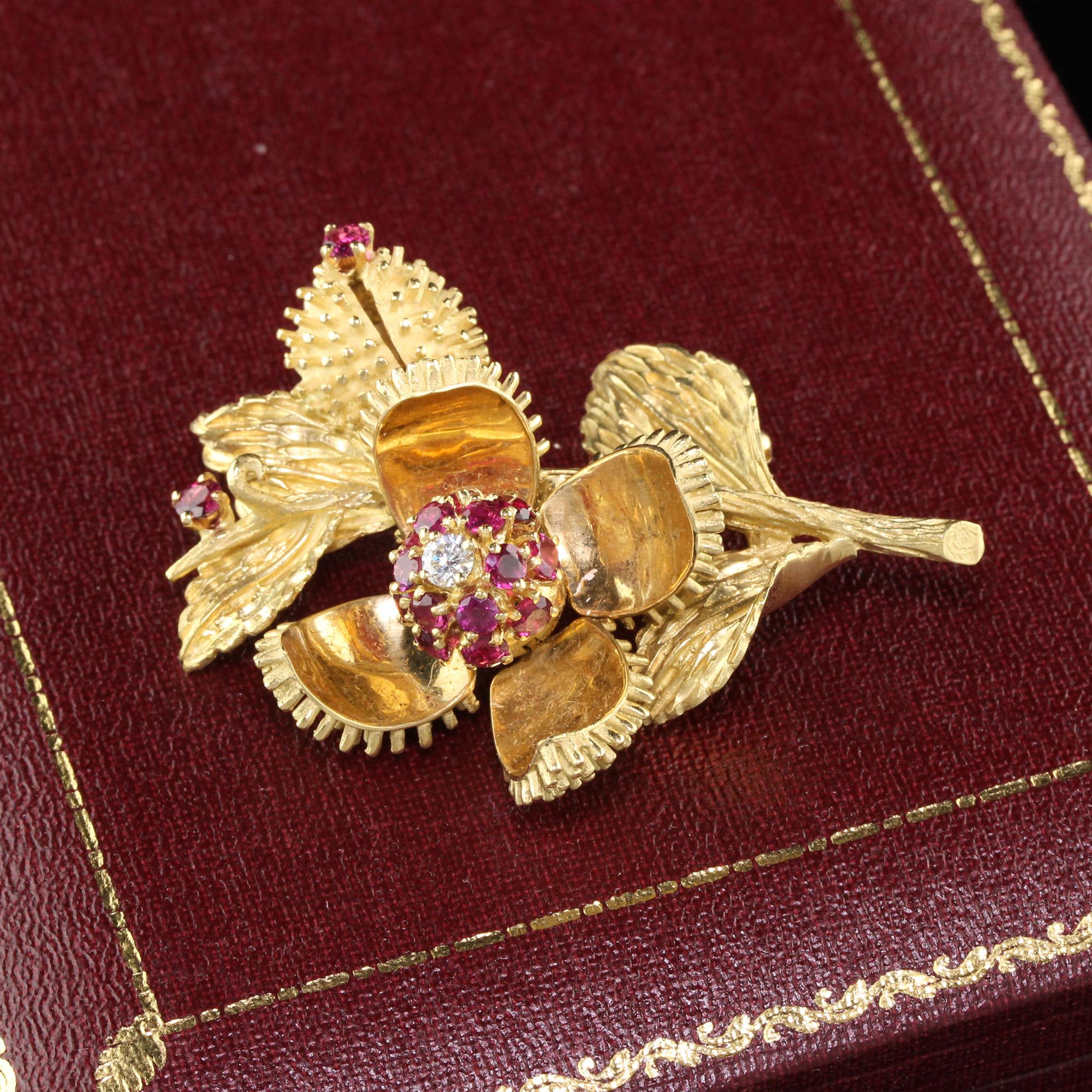 Vintage yellow gold Tiffany & Co. flower brooch with rubies & diamonds. The larger flower opens and closes manually to reveal the diamond and rubies.

Metal: 18K Yellow Gold

Weight: 29.4 Grams

Diamond Weight: Approximately 0.15 cts 

Diamond