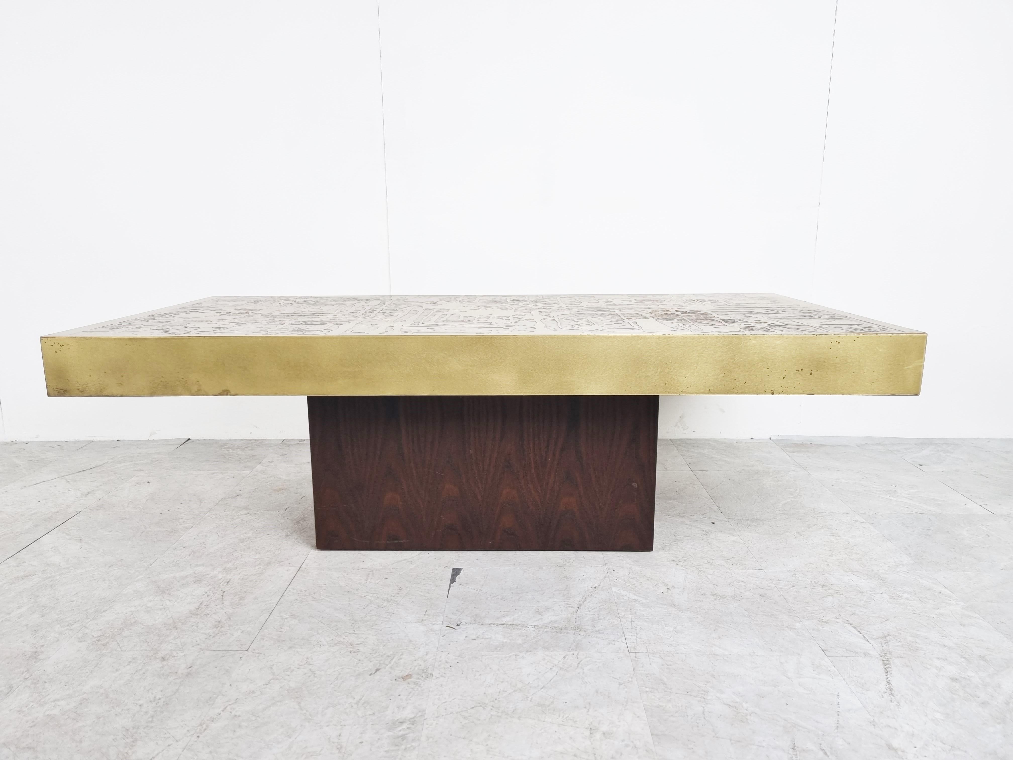 Brutalist oxidized and etched brass coffee table by Bernhard Rohne.

Eye catching coffee table on a brown wooden base.

Beautful patina on the brass, good overall condition

1970s - Germany

Dimensions
Height: 50cm/19.68
