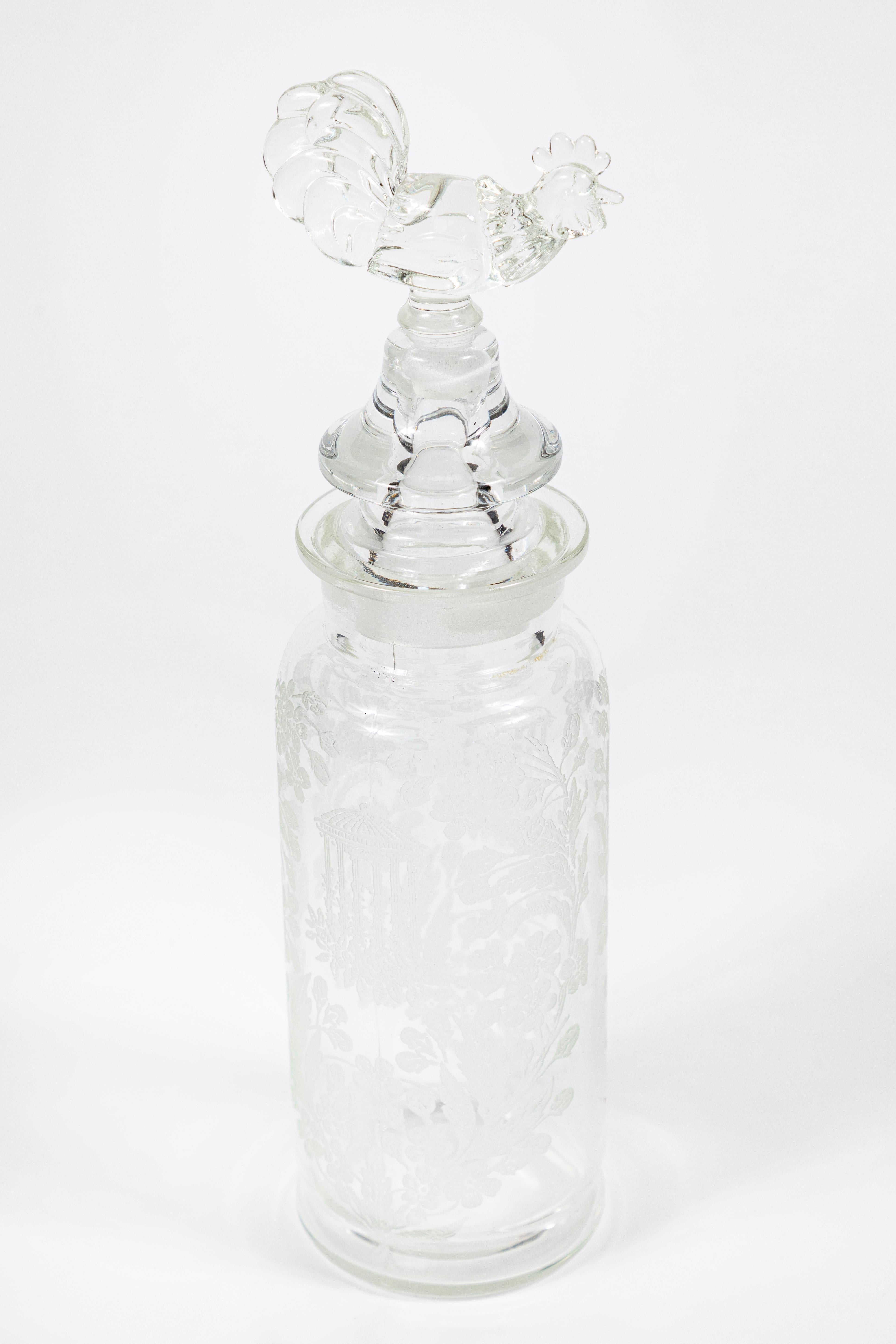 A beautiful vintage cocktail Shaker from the 1930s with a romantic intricately acid etched gazebo and floral design.

The Shaker with its rooster motif finial stands 13 inches high, including the finial, and has an approximate 3 and ½ inch base.