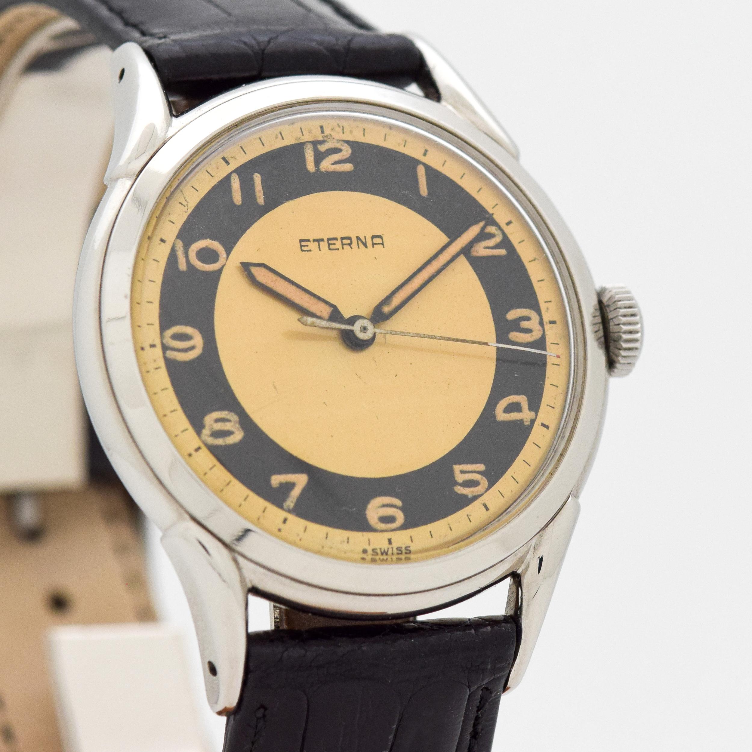 1950's Vintage Eterna Stainless Steel watch with Original Two Tone Black and Gold Dial with Arabic Numbers. 36mm x 43mm lug to lug (1.42 in. x 1.69 in.) - 15 jewel, manual caliber movement. Triple Signed.