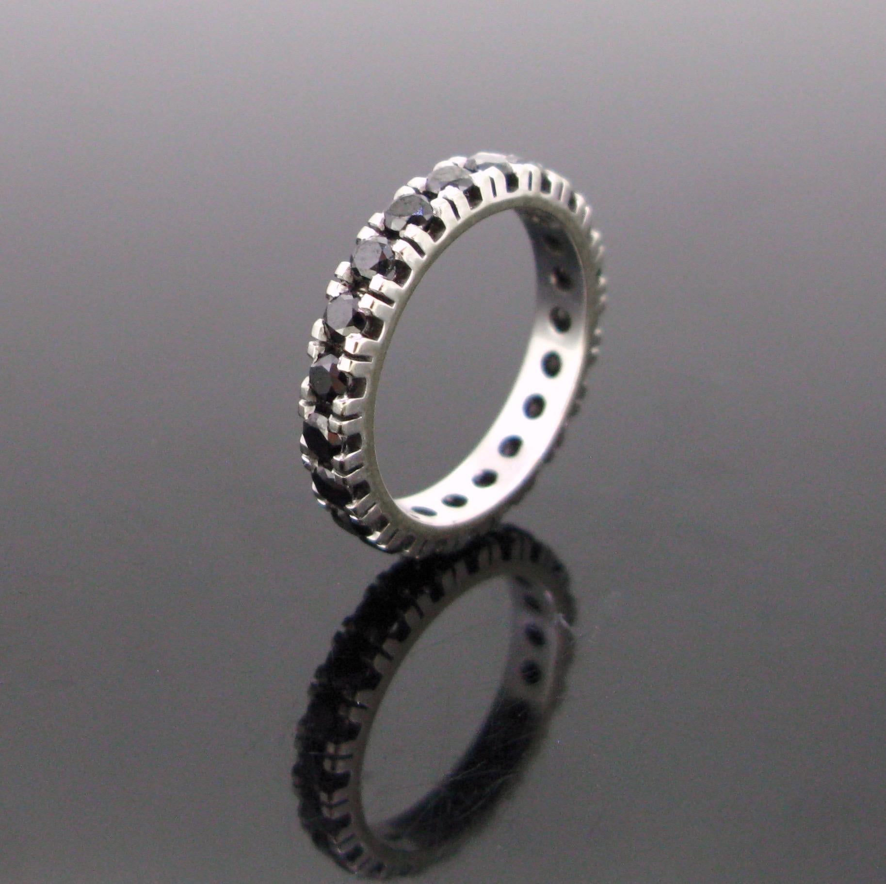 Weight:	4.69gr


Metal:		18kt White Gold


Stones:	21 Black Diamonds
•	Cut:	Round Cut  
•	Total Carat Weight:	1.50ct approximately


Condition:	Very Good


Comments:	This lovely eternity ring is fully made in 18kt white gold. It is set with 21 round