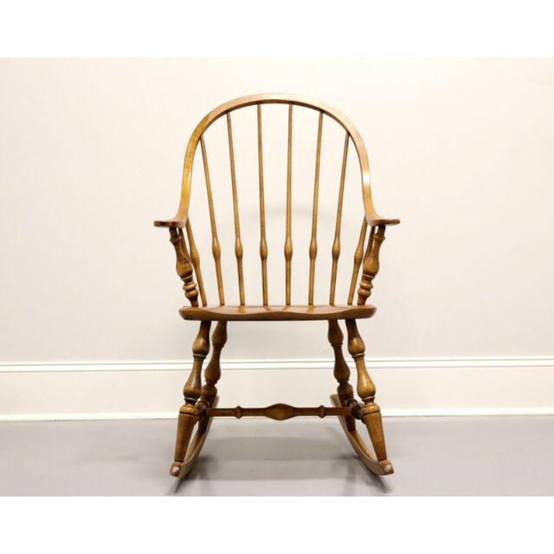 A Windsor Style rocking chair by Ethan Allen, from their Circa 1776 Collection. Solid maple with bowback, turned spindles, turned legs and stretcher. Made in the USA, circa 1980's.

Style #: 18-9710-218

Measures: Overall: 24.5 W 31 D 39.75 H, Seat: