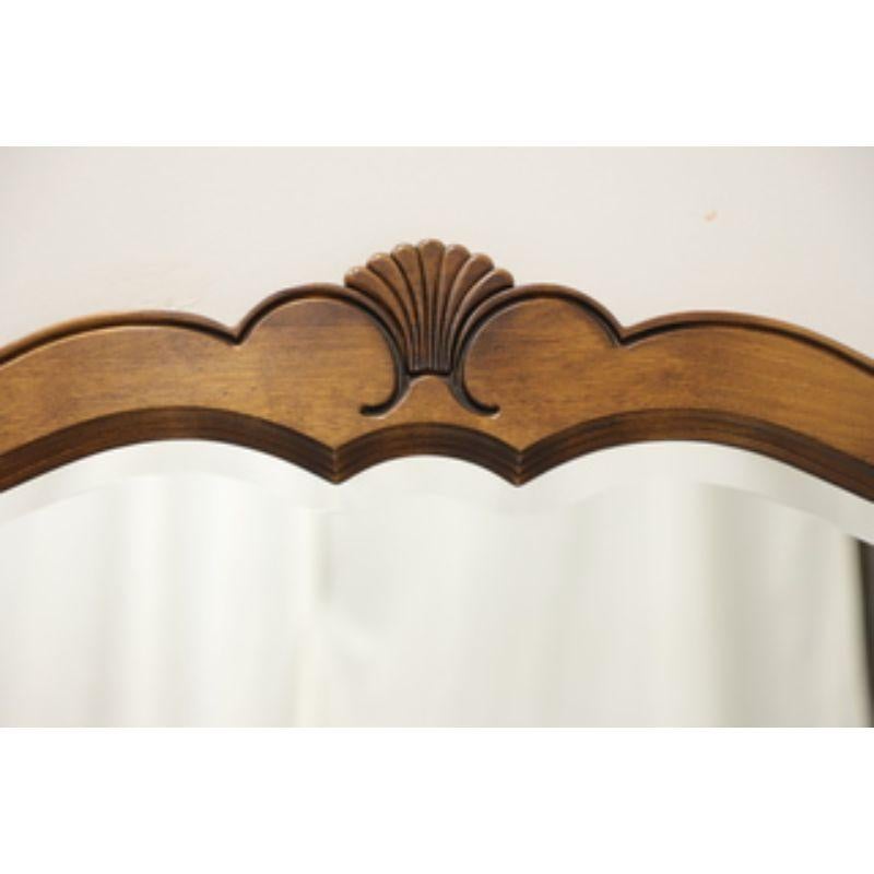 A wall or over dresser mirror in the French Country Style by Ethan Allen. Beveled mirror glass and walnut frame with a slightly distressed finish. Decorative carved fan to top. Made in the USA, circa 1988.

Measures: 43W 1D 40.75H, Weighs