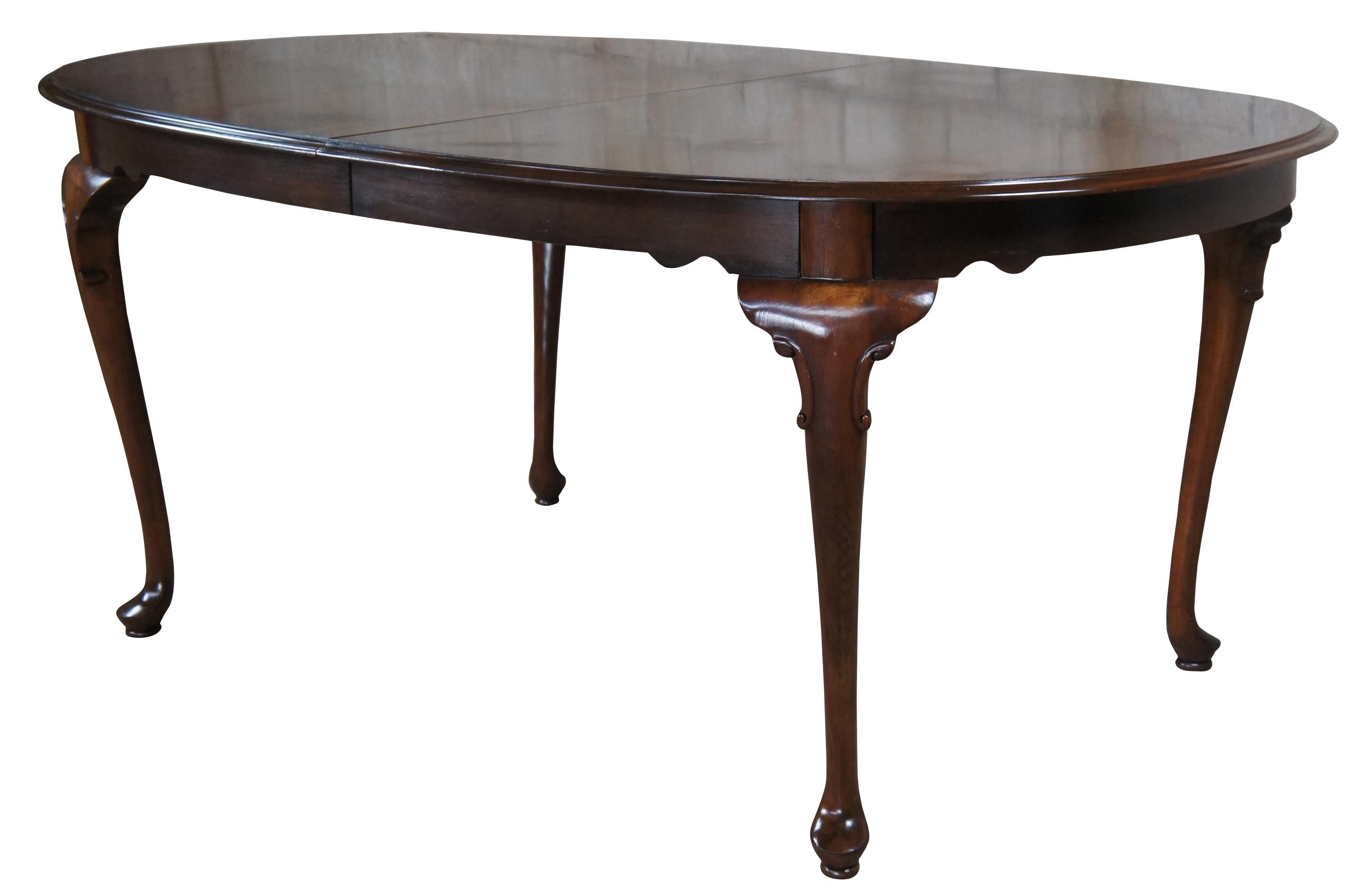 Ethan Allen Georgian court oval extension table, Circa 1980s. Made from Cherry with 2 leaves for extension, queen anne legs and pad feet. 11-6214

Measures: 44