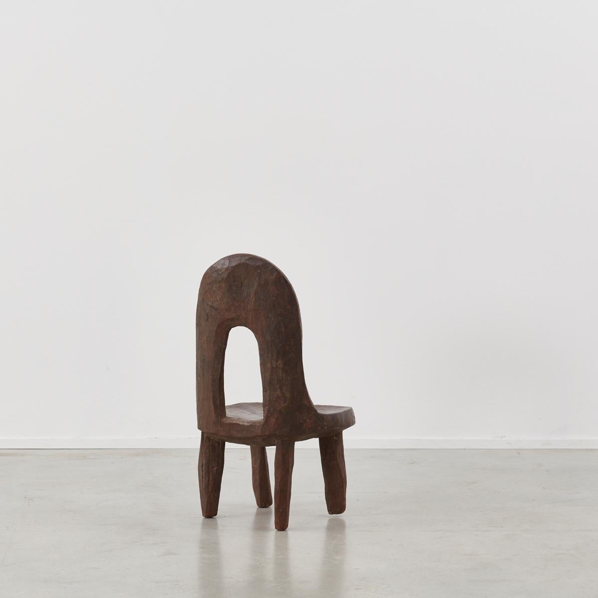 This chair from Ethiopia has a truly lovely presence. It was crafted from a single piece of dark hardwood. Pretty impressive considering the density of the wood involved. Each leg is not uniform, but it does function as intended and the seat can