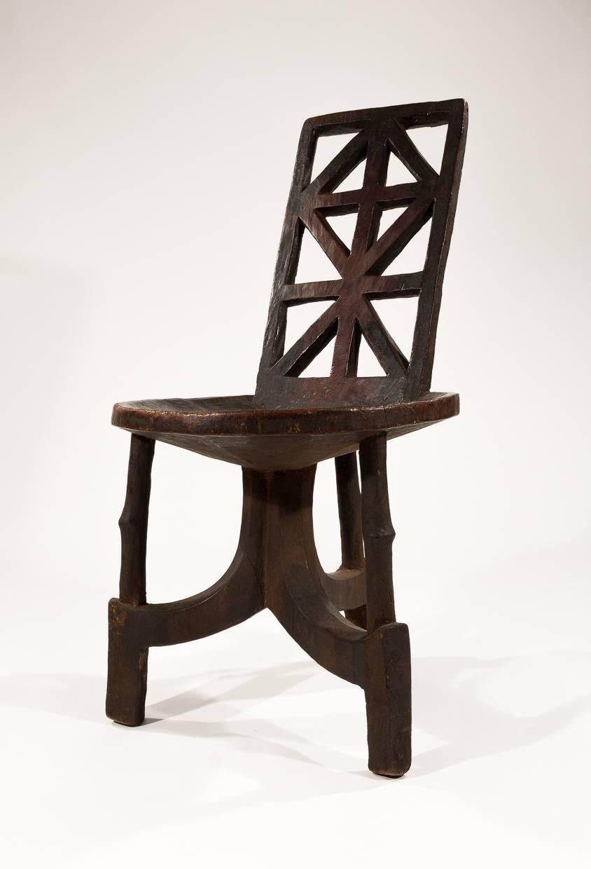 A beautiful hand-carved Ethiopian chair. It is carved from heavy, dense wood and has a wonderful finish and rich patina. A very good example which is hard to come by these days.