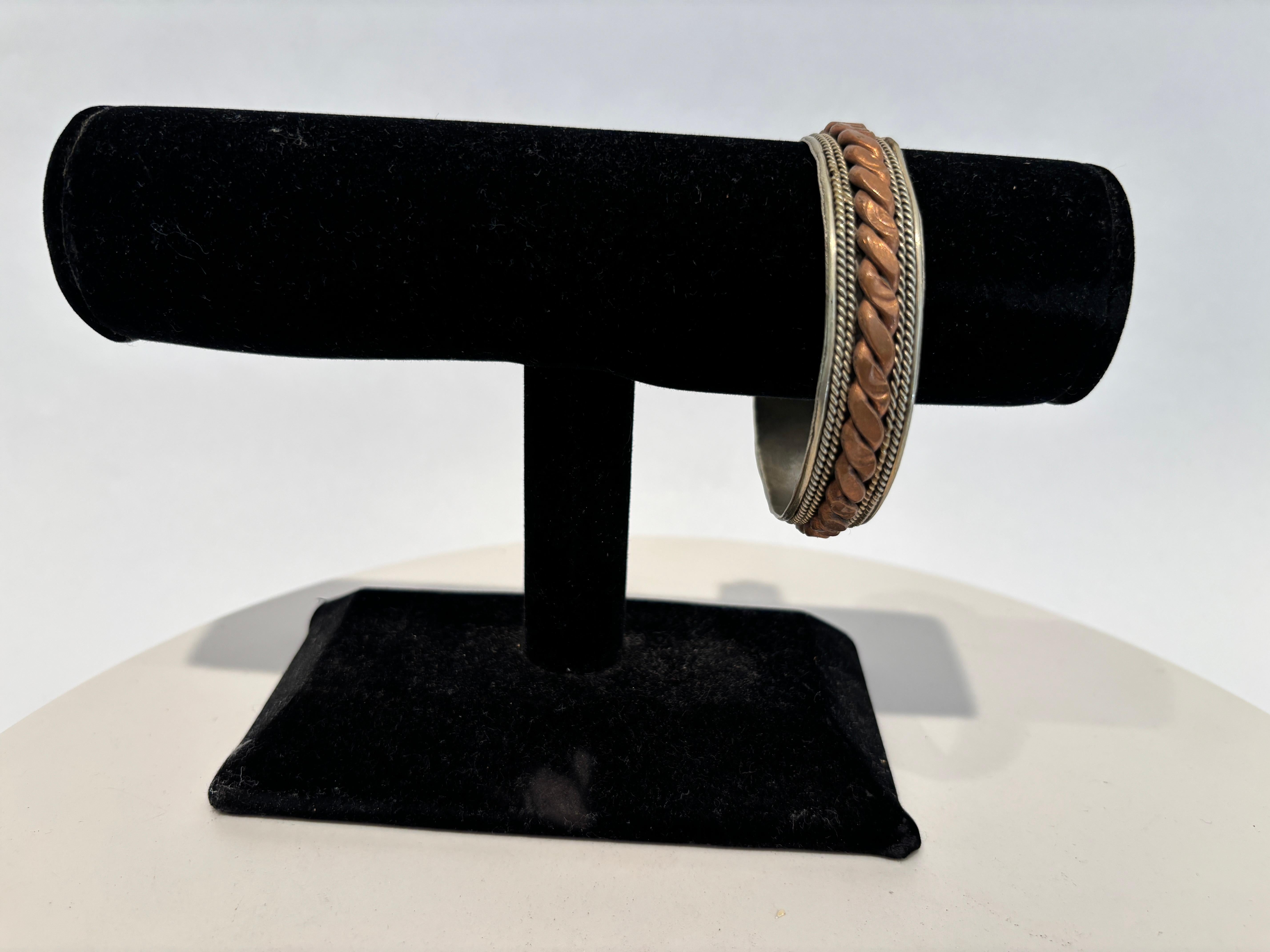 Bracciale etnico d'epoca berbero nordafricano ornato in argento e rame, probabilmente proveniente dal Nord Africa (come Algeria o Marocco, Egitto). 
Bracciale vintage in metallo bicolore, caratterizzato da una combinazione di metalli argentati e