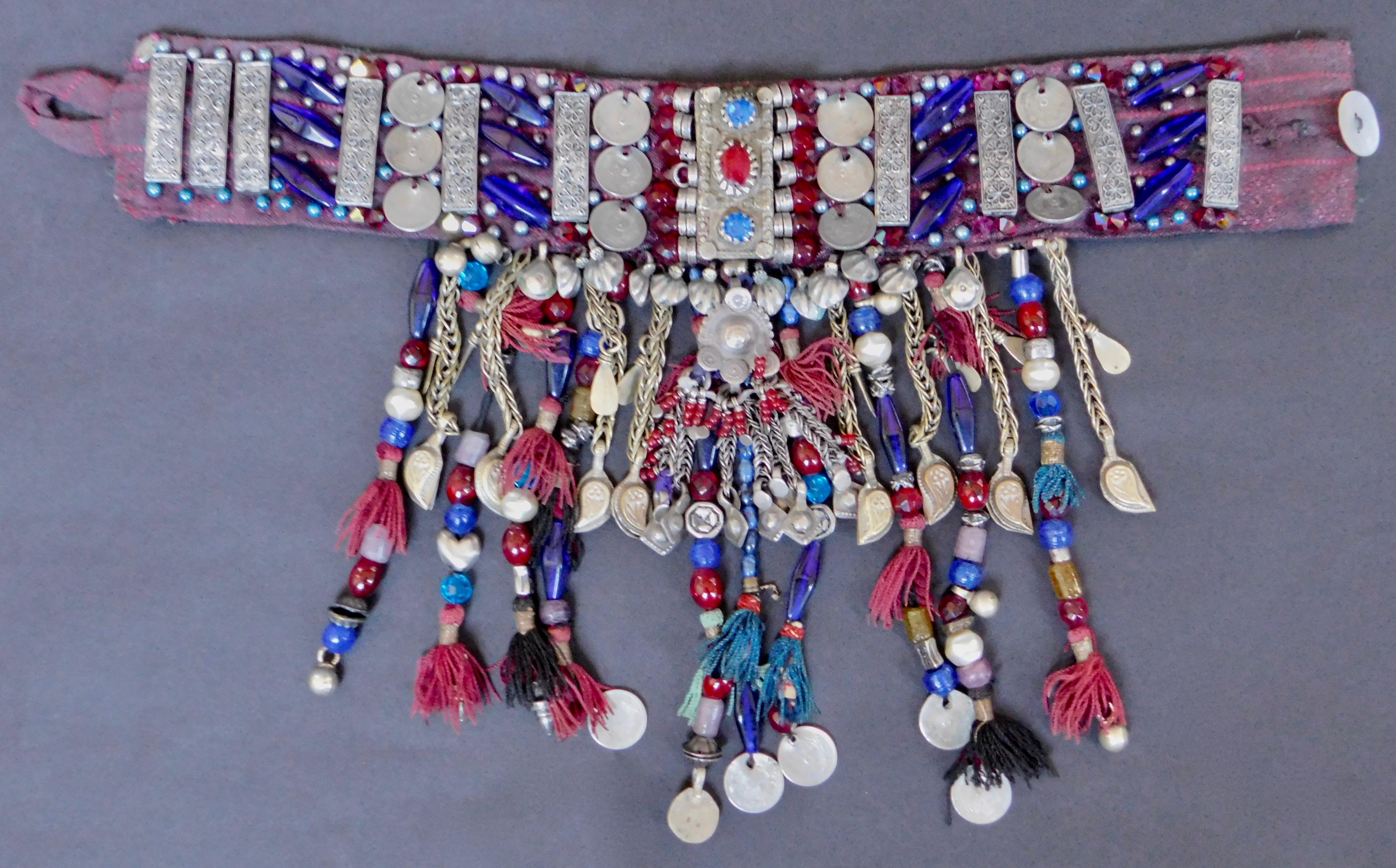 An ethnic style choker necklace made in the 1970's by a Belgian designer. The choker is constructed from soft fabric which is adorned with hand sewn antique Turkish coins and tassels as well as glass beads and chains. absolutely one of a kind.