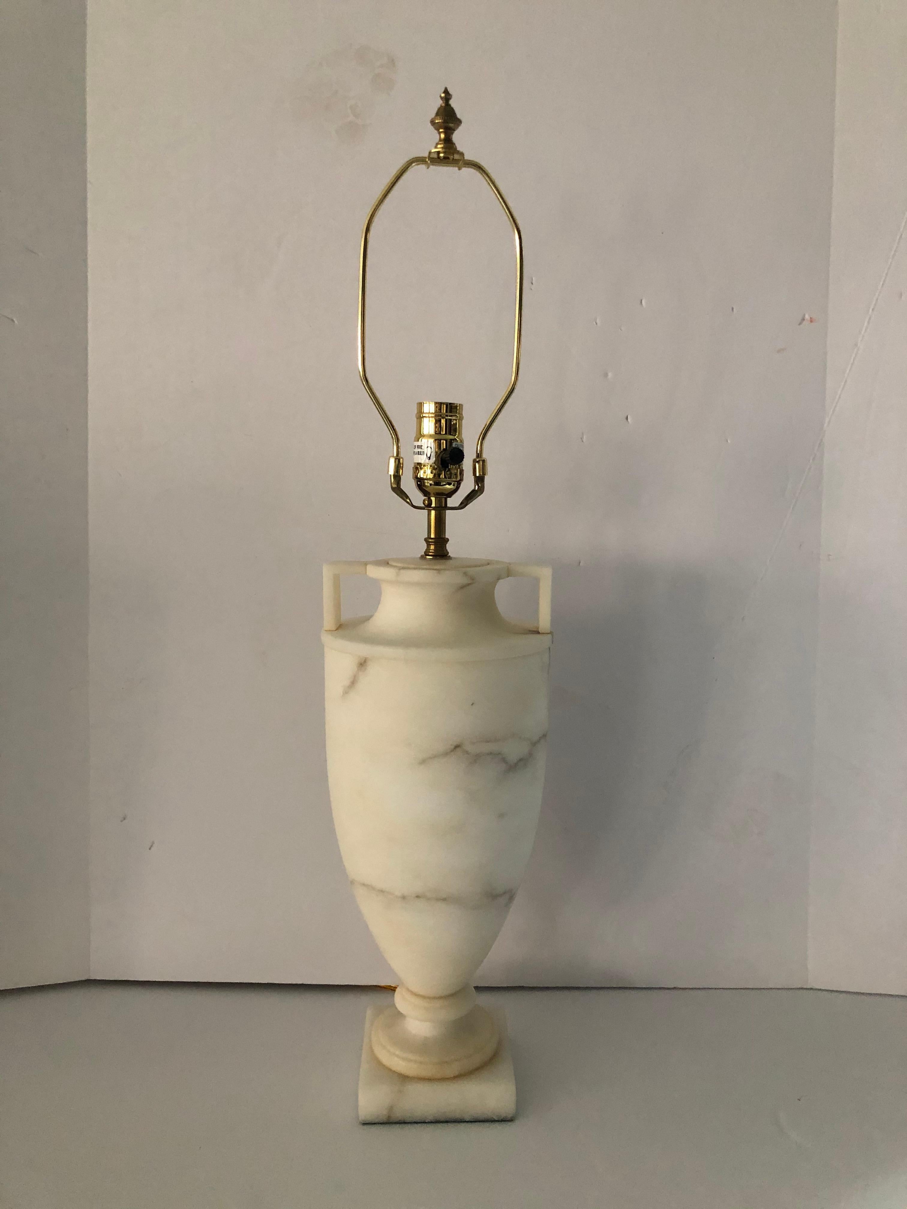 A sophisticated urn form lamp by Vaughn comprised of solid alabaster with a square base and squared handles. The veining in the alabaster is very subtle, adding to the beauty of the lamp. The shade is in black matte and lined in gold paper. The