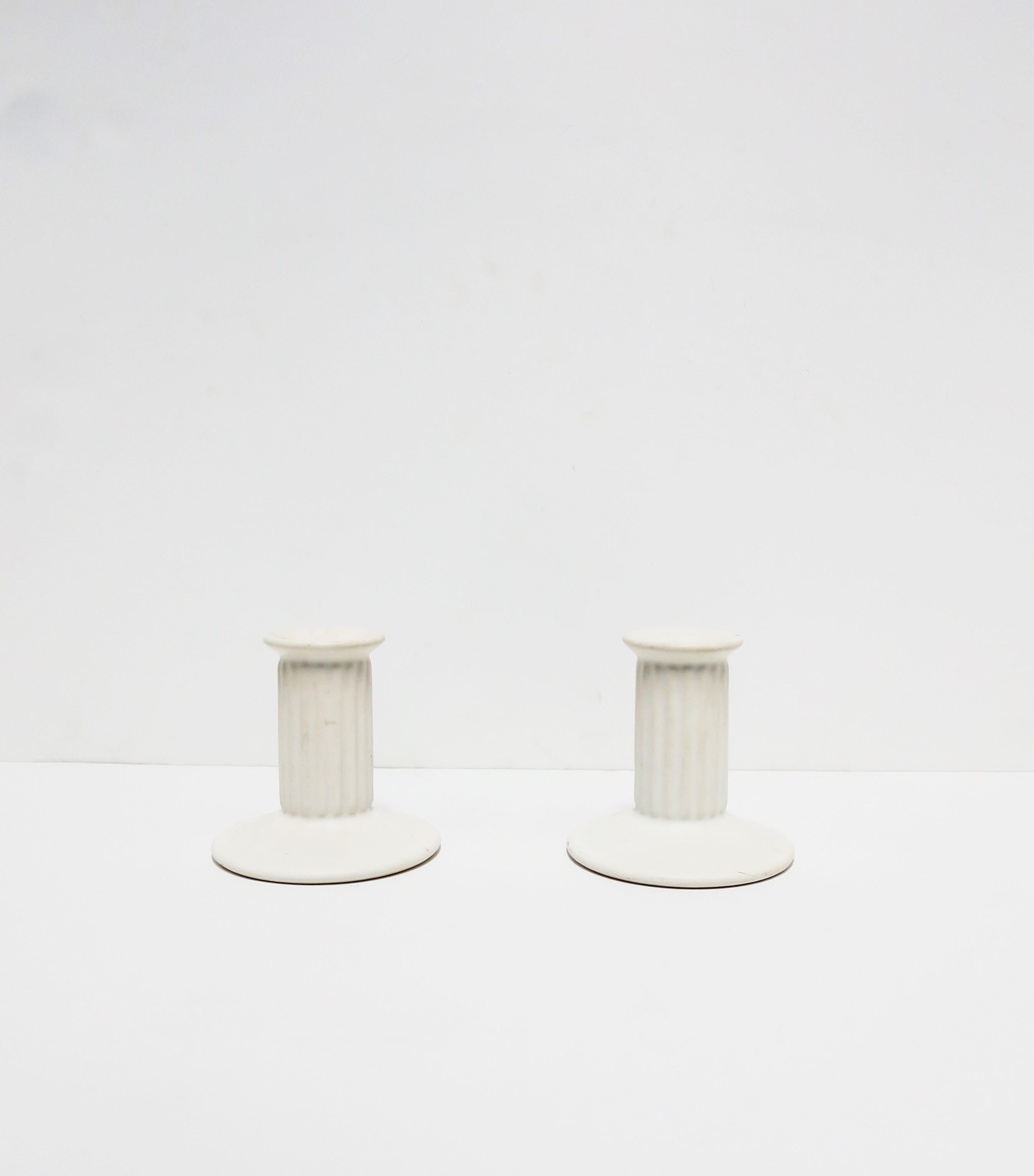 A vintage pair of white ceramic matte 'column' candlestick holders in the Neoclassical style, circa 1960s-1970s. Made in Portugal. Both marked on bottom as shown in last image. Dimensions: 4.5