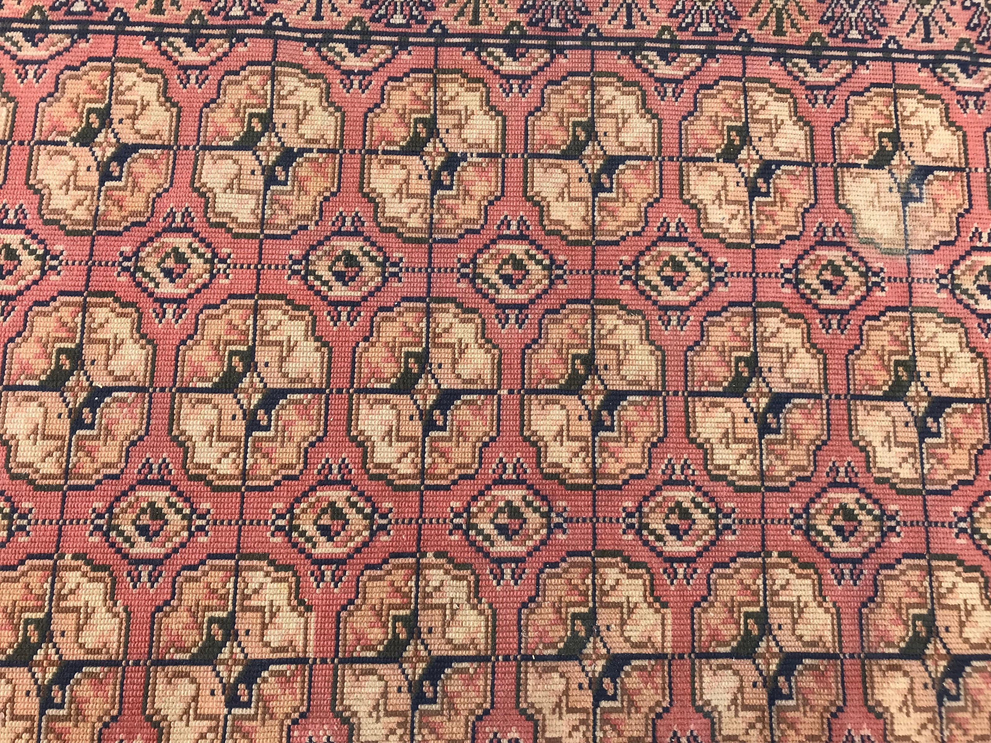 Little mid-20th century European knotted rug with a Turkmen Boukhara design and a light brown color, entirely knotted with wool velvet on cotton foundation.