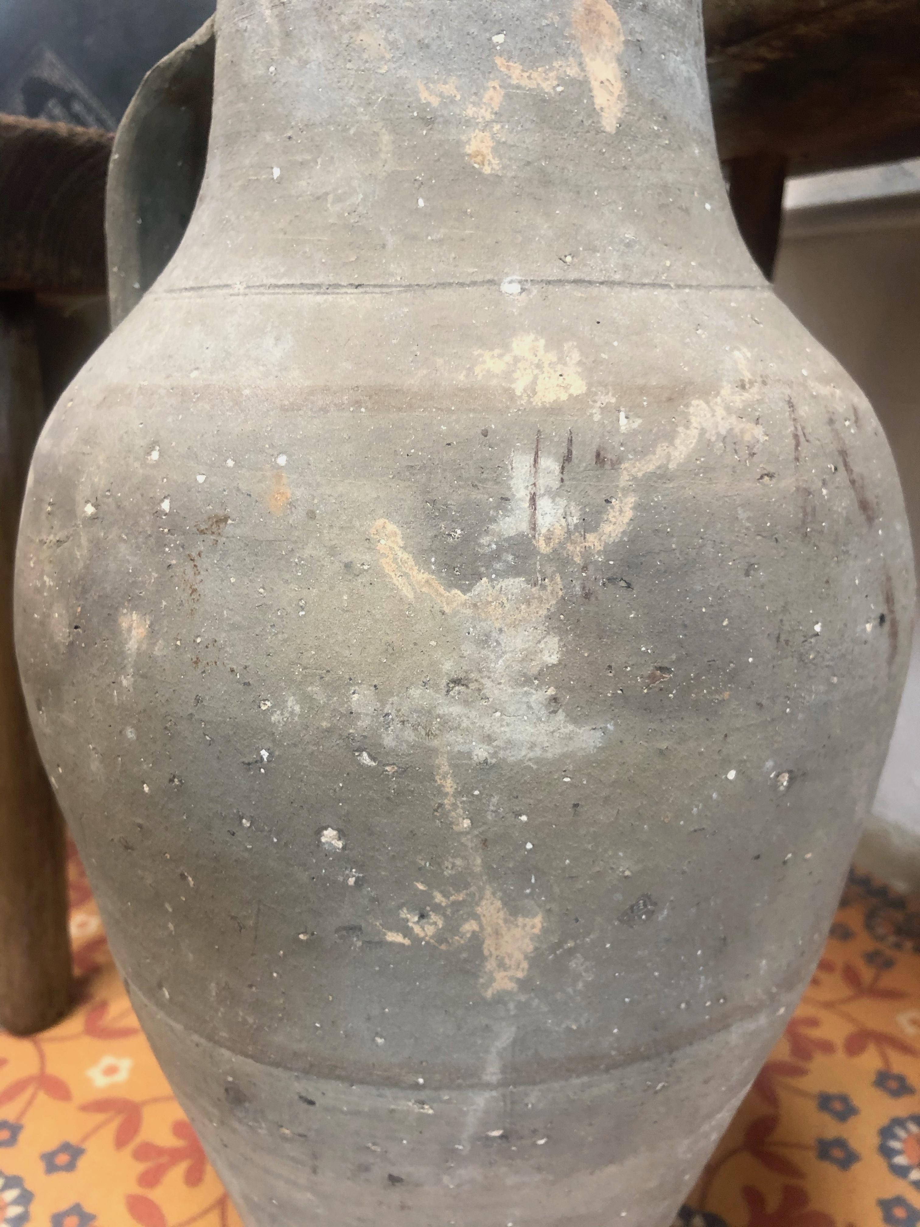 An antique sand toned ceramic vase from Europe featuring one handle.

Dimensions: 8