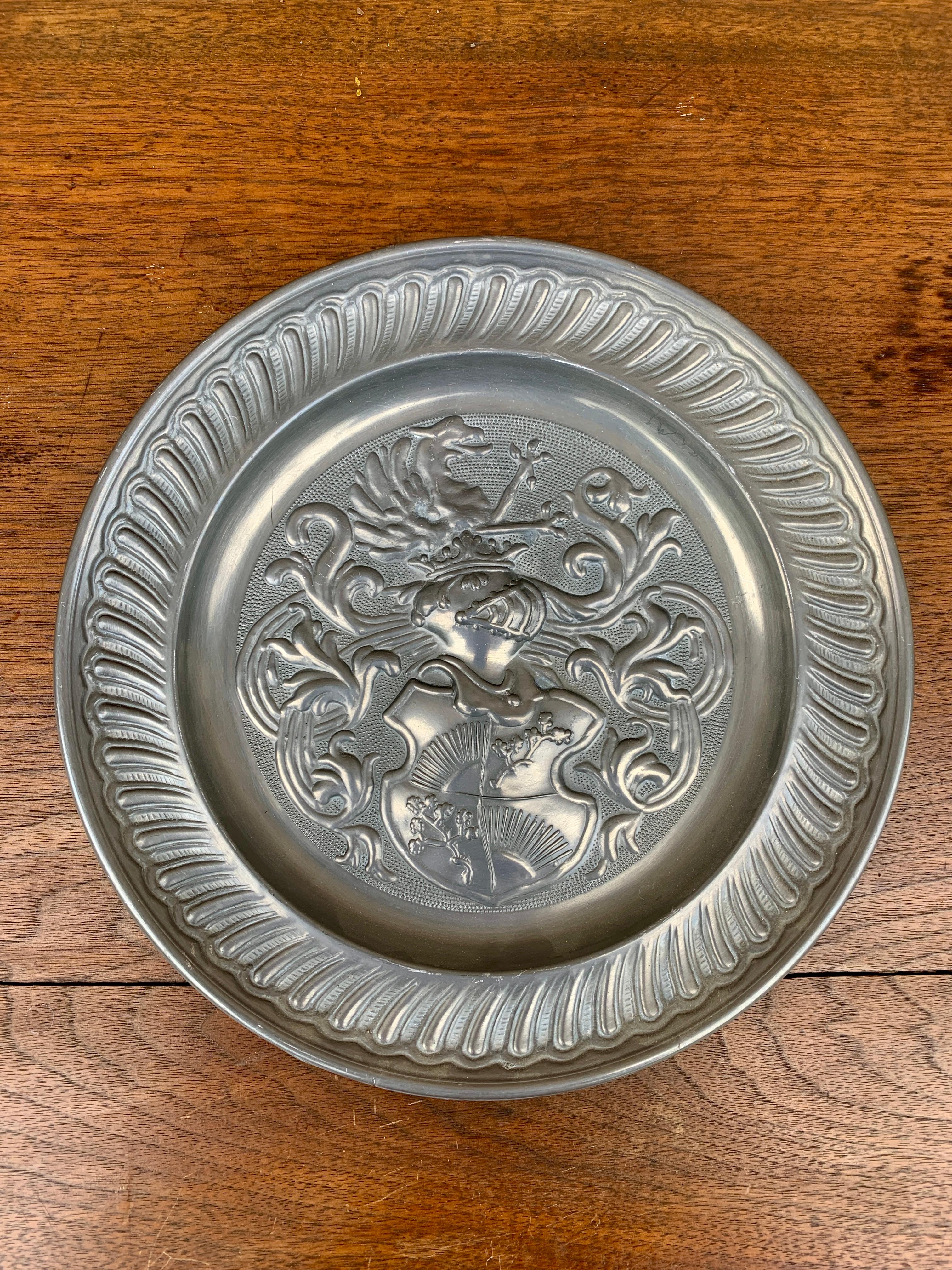 A beautiful pewter wall plate featuring a heraldic coat of arms with a knight

Germany, Mid-20th Century

Measures: 9