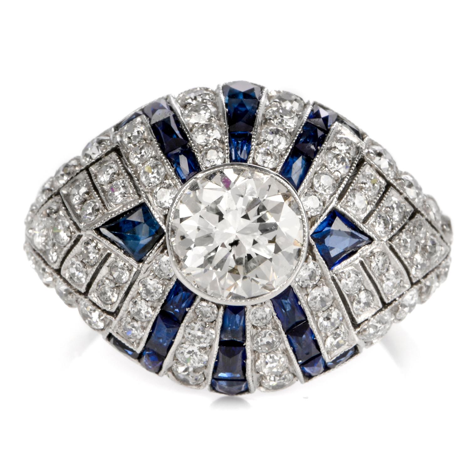 This alluring vintage engagement cocktail ring with European diamond and blue sapphires is designed as a gracefully domed plaque constructed in platinum, weighing approx. 4.8 grams and measuring 16mm wide and 5 mm high. The centrally positioned