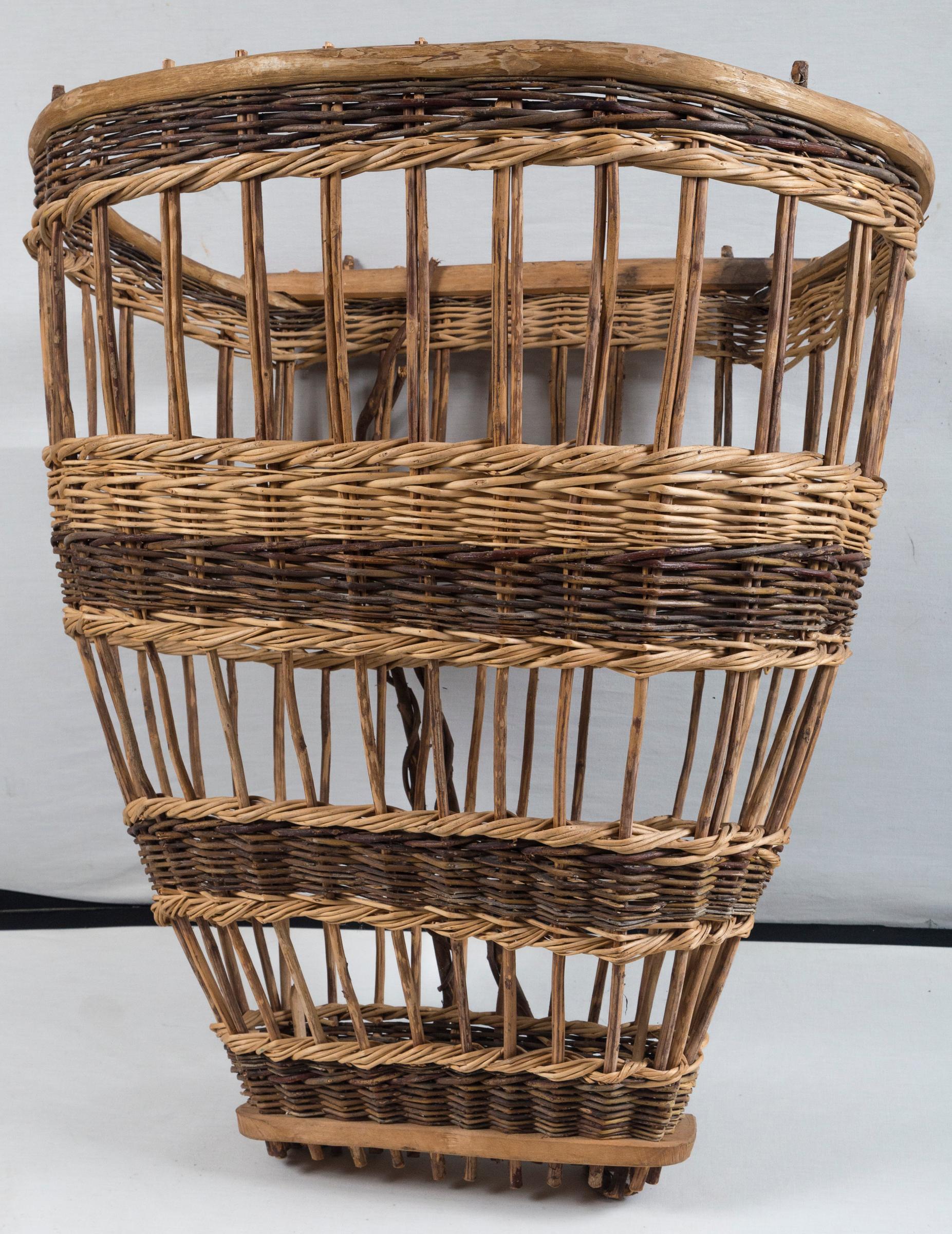 Vintage European field basket, 20th century. Woven wicker and wood. Used for hand-harvesting and designed to be worn on back.