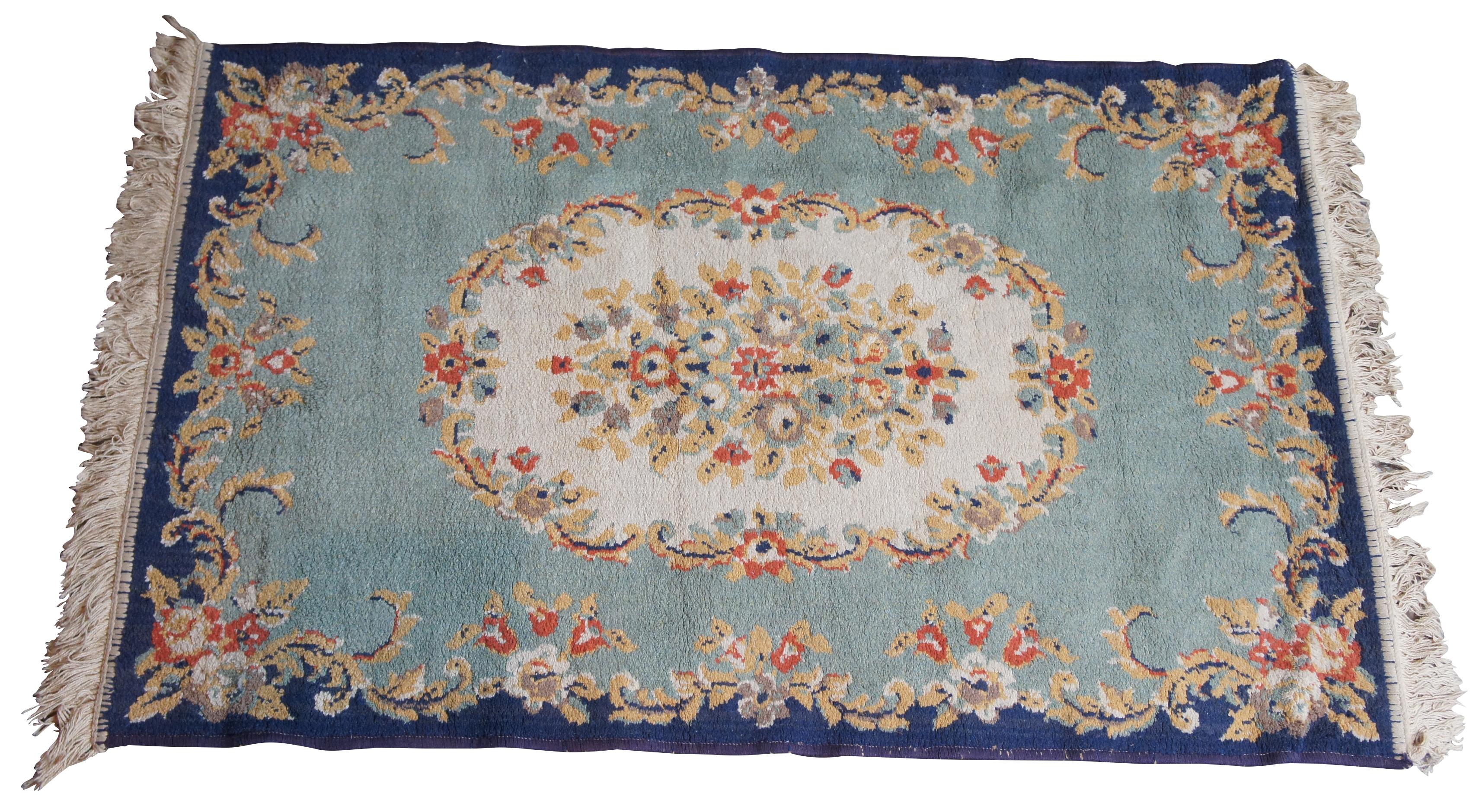 Aubusson area rug with a field of blues accented by gold, creme and red flowers. Measure: 46