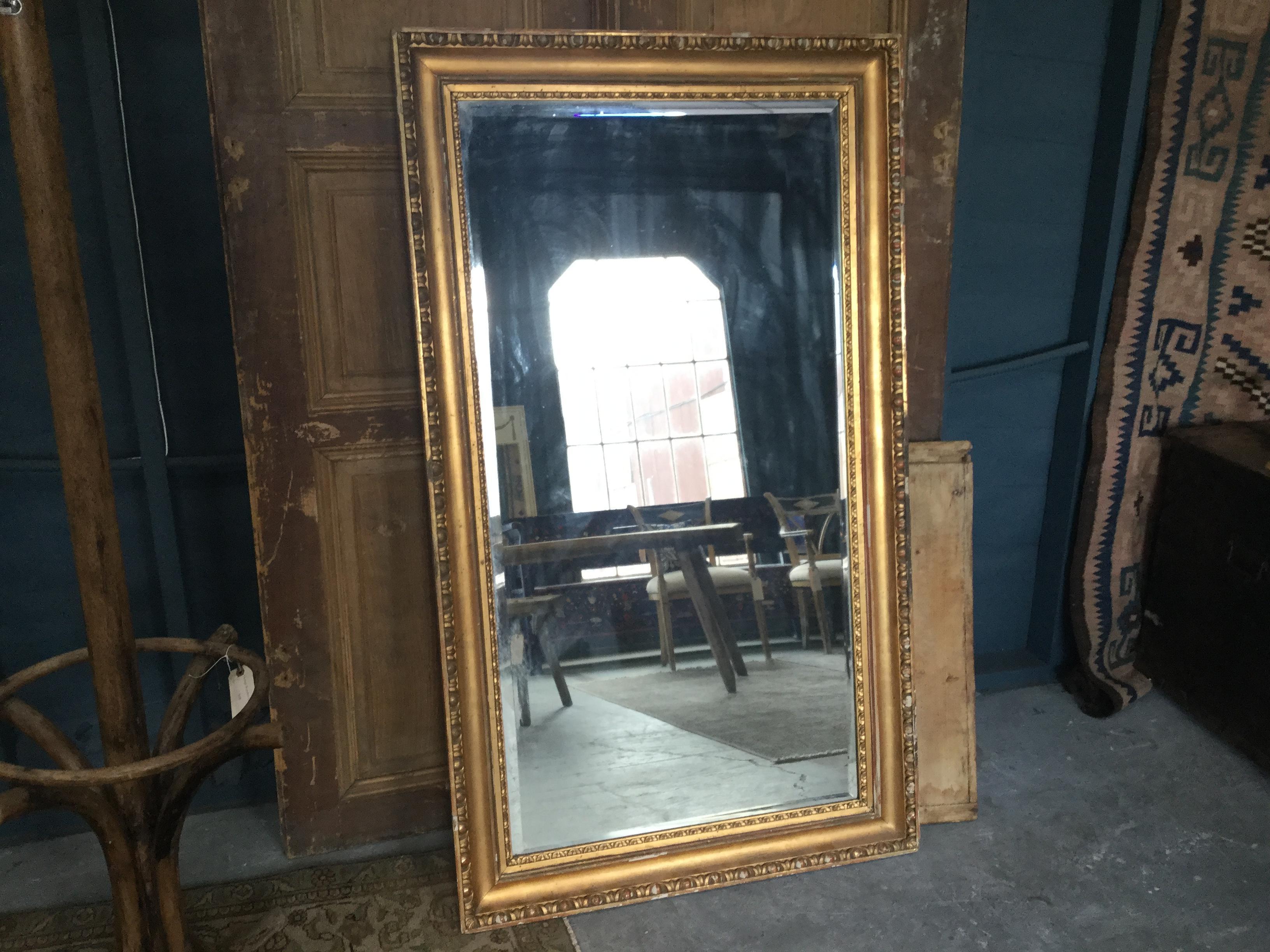 Vintage European gilded mirror with fine detailing. This neoclassical mirror is a beautiful accent in any type of space.